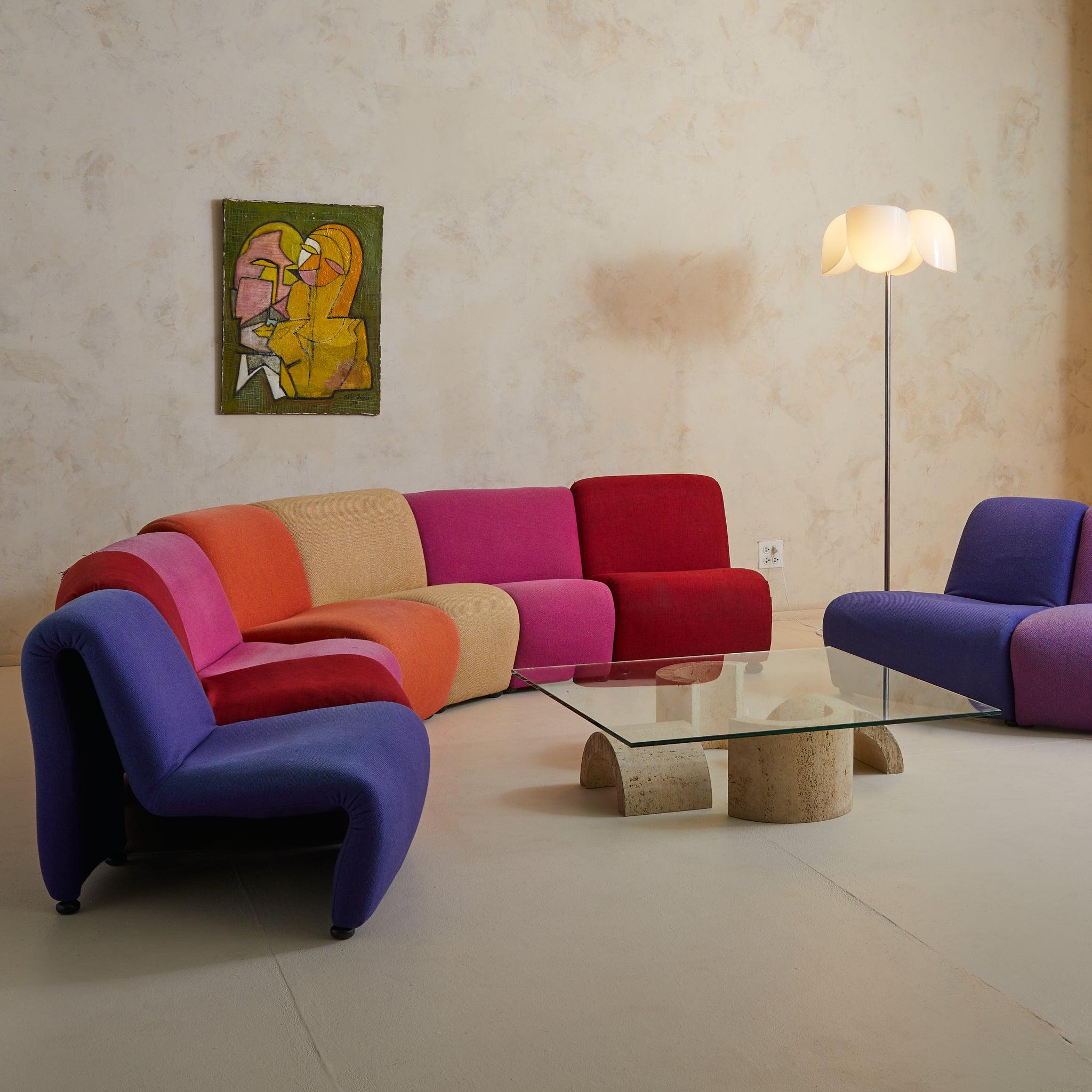 This rare nine-piece serpentine sectional—attributed to French designer Étienne Fermigier, 1970s—channels the modular exuberance of postmodern living. Each bulbous module retains its original upholstery in a saturated spectrum from oxblood to