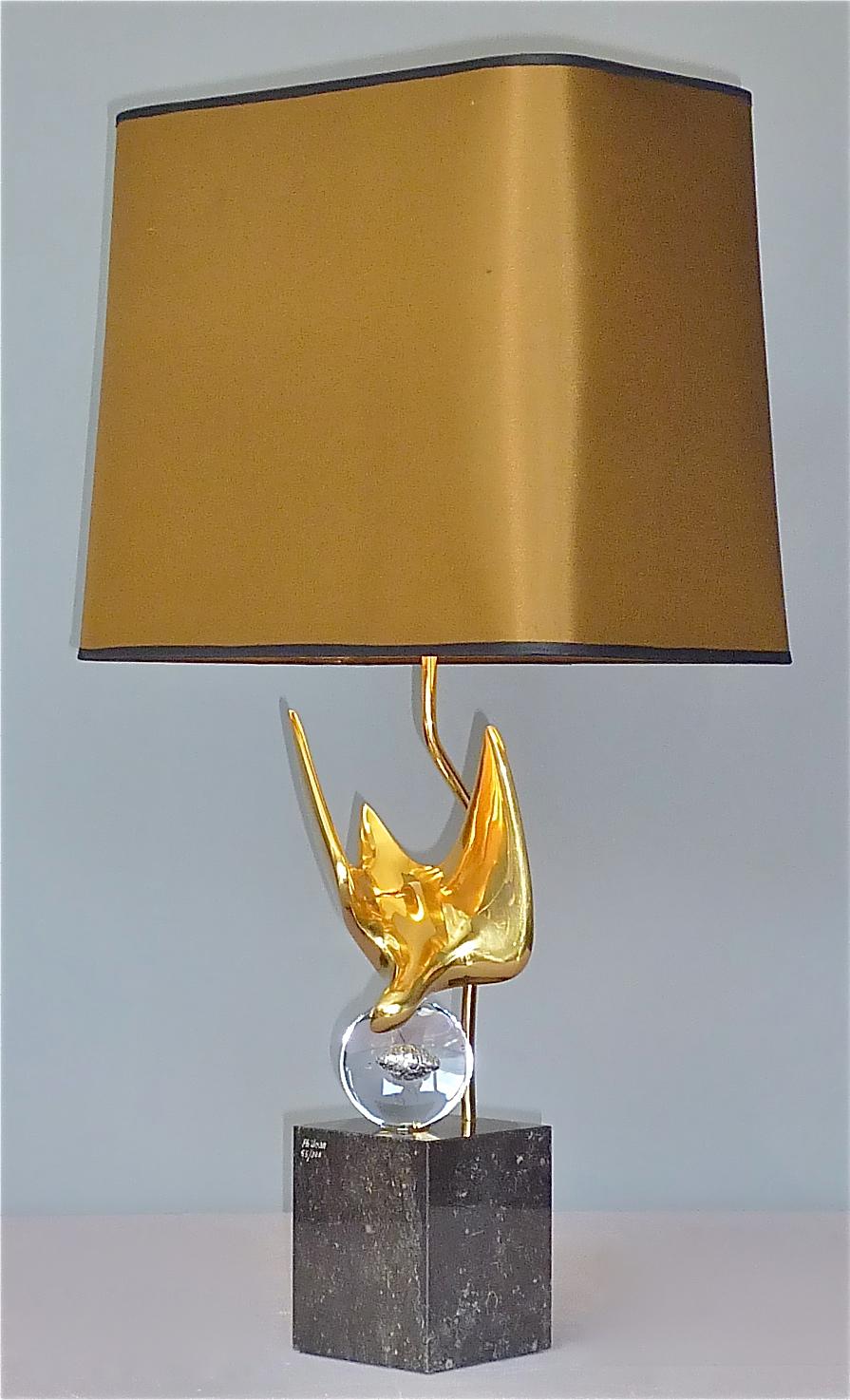 Superb and very rare sculptural French abstract bird table lamp by artist Philippe Jean, France around 1970s. The table lamp has a square heavy black-grey granite base signed Ph. Jean and 55/300, so from a limited edition, a crystal glass globe