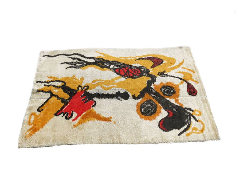 Wool pile shag tapestry/carpet designed by Joan Miro featuring a mixture of red, blacks, yellow, beige and brown. Signed 
