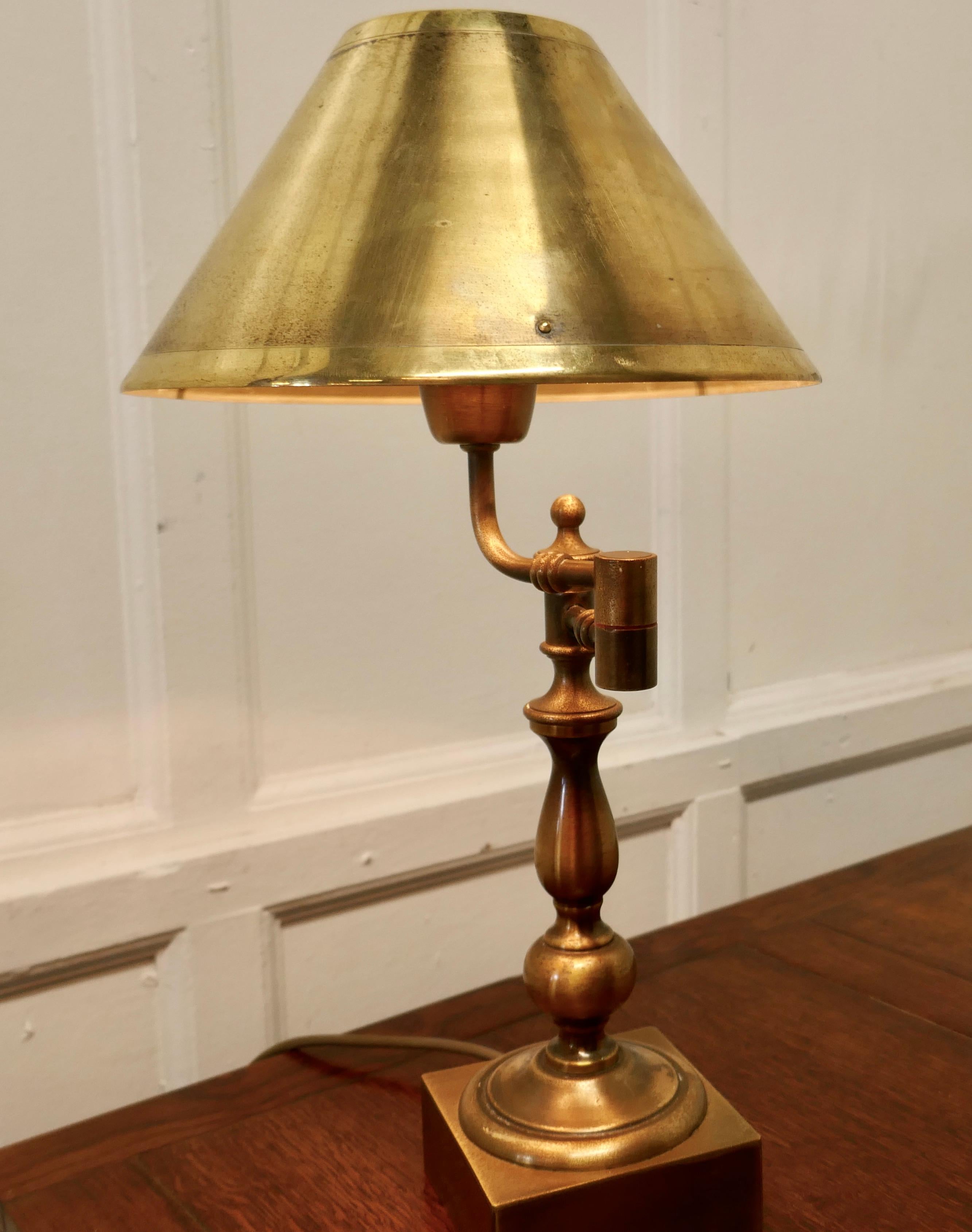 French adjustable brass desk lamp 

This is an unusual piece, the lamp has a heavy brass base which supports an articulated arm, this can be moved to adjust the position of the light
The lamp works well and has a brass cone shaped shade
A very