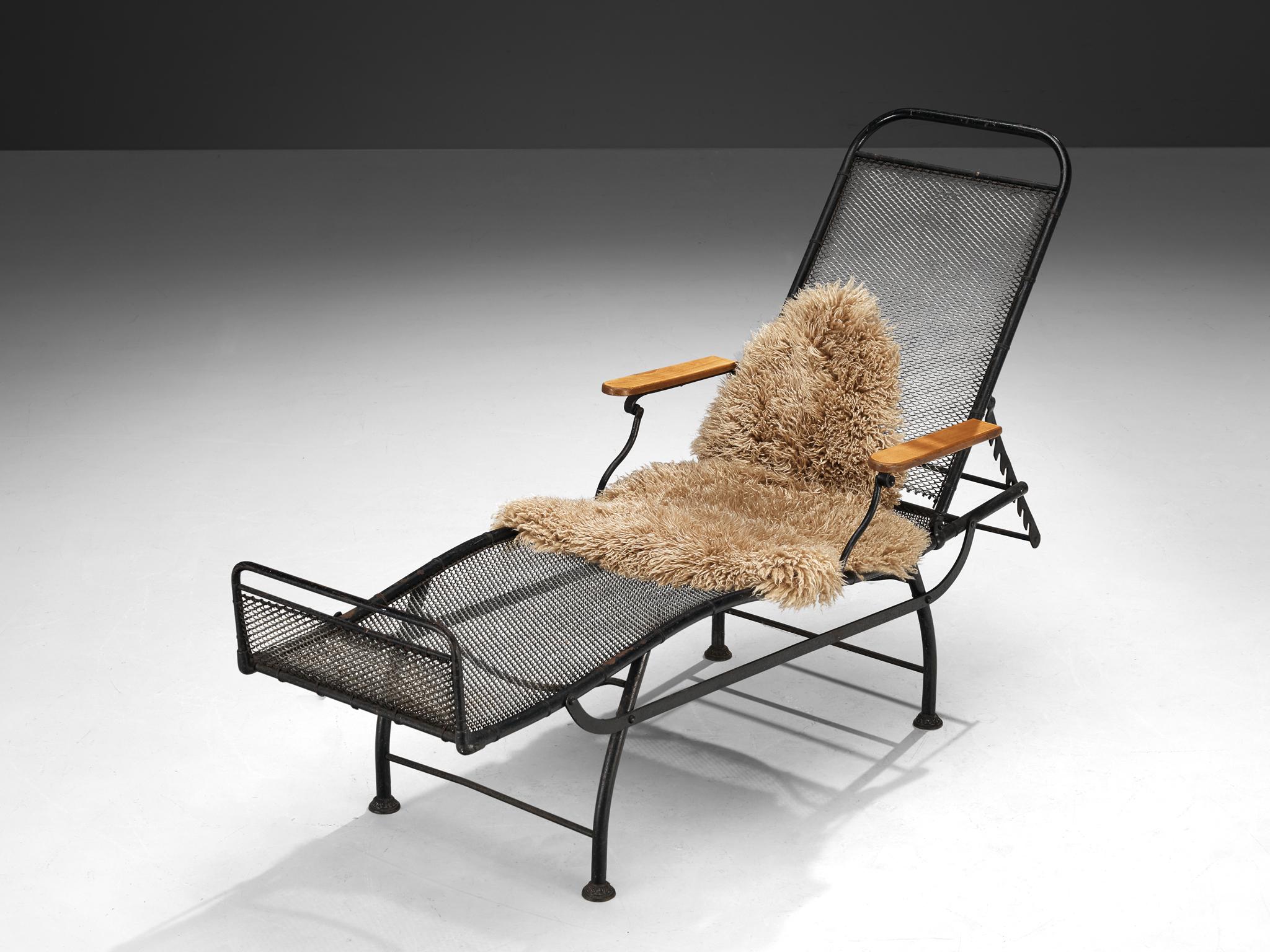Chaise longue, coated iron, wood, France, 1930s

This functional, adjustable daybed features a frame in black metal and a seat of spiral metal webbing. The backrest is adjustable in different angles and allows the user to switch from an upright