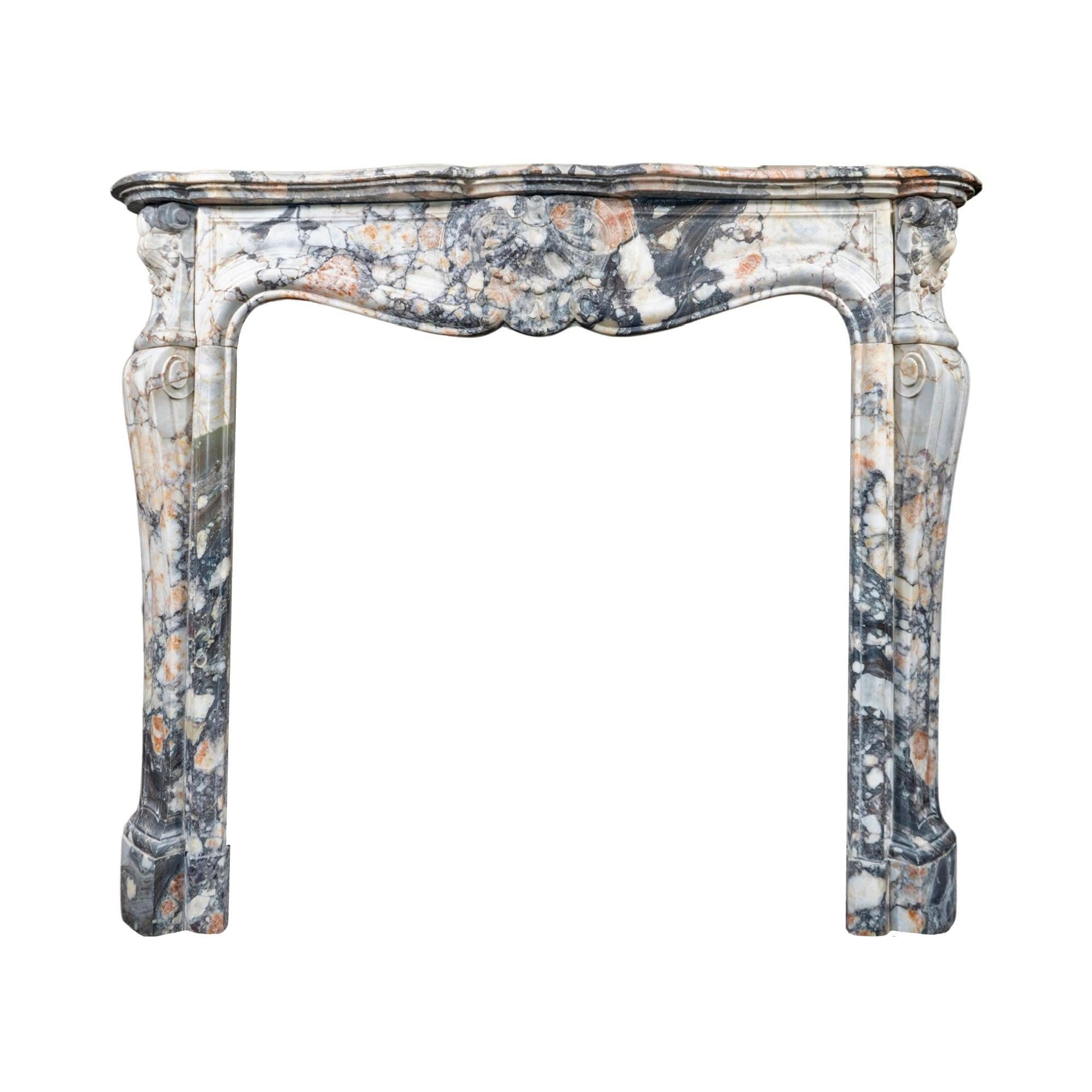 Crafted in France during the 1890s, this French African Breccia Marble Mantel boasts intricate carvings throughout the piece. Made from stunning African Breccia stone, this mantel is a perfect blend of elegance and durability, making it a timeless