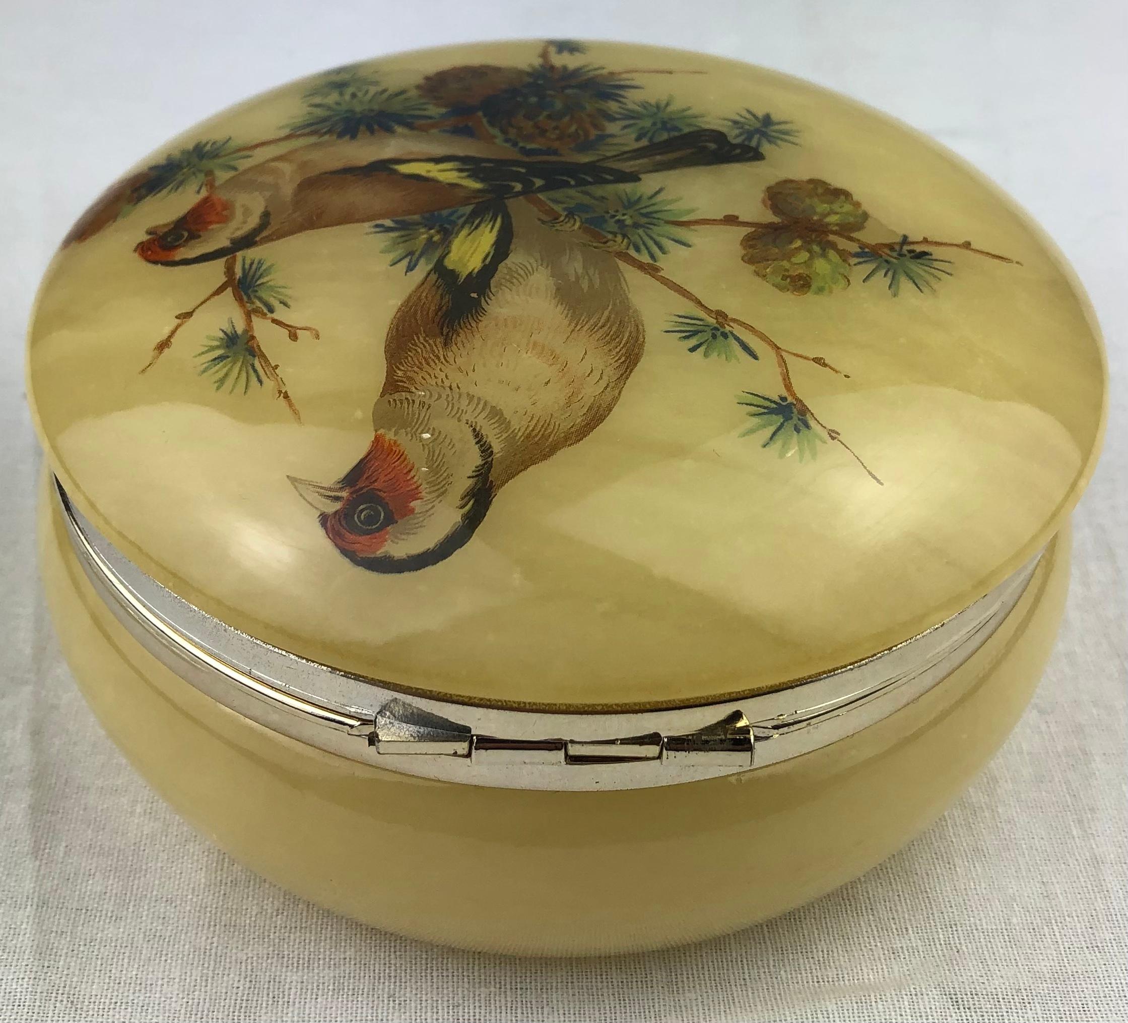 Beautiful hand painted alabaster trinket, or jewelry box. 

The decoration consists of lovely birds and foliage, colors include blue, yellow, green, and different shades of brown. Gorgeous hand painted box, makes a lovely gift to oneself or