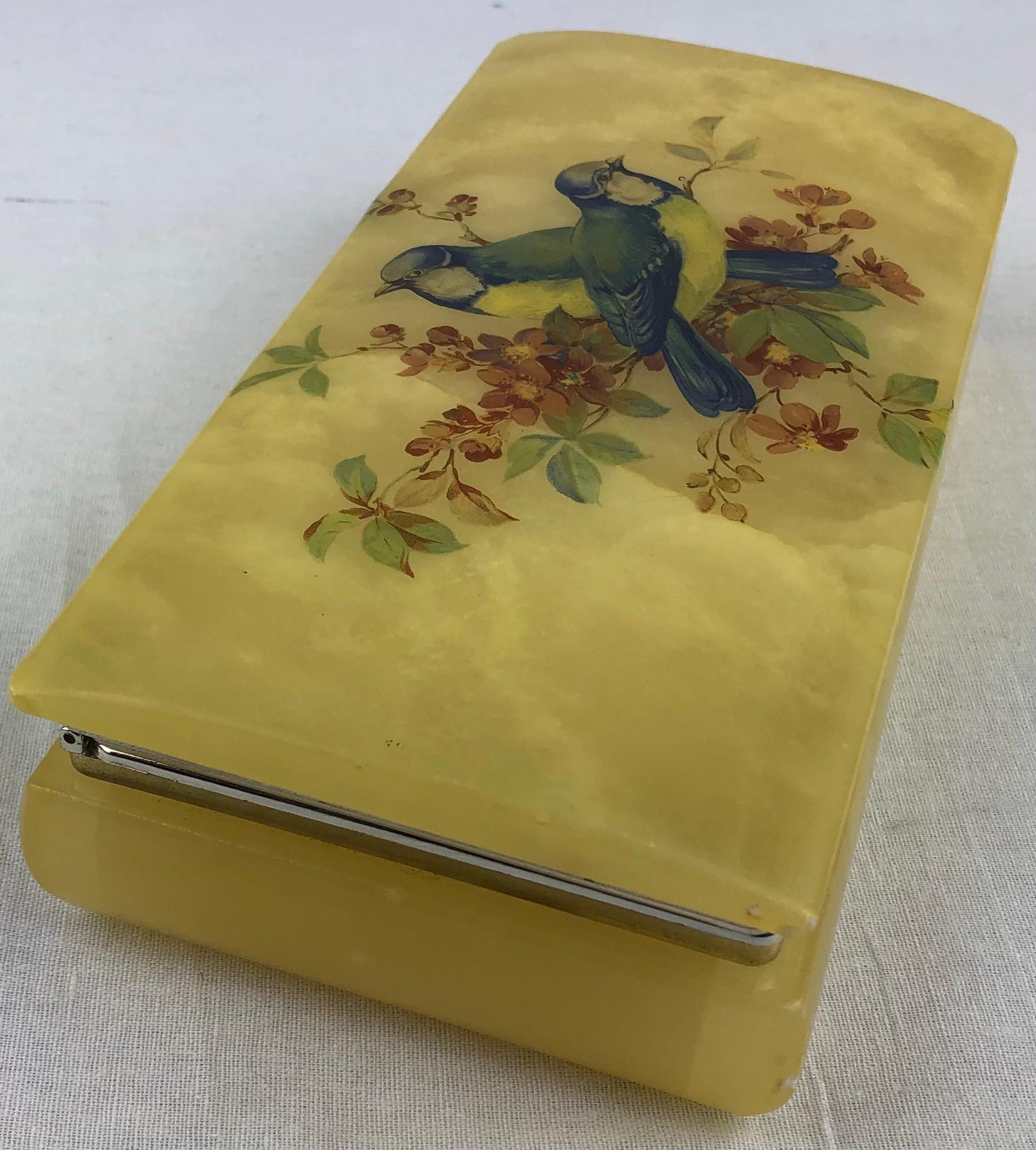 Beautiful hand painted alabaster decorative trinket, or jewelry box. 

The decoration consists of two lovely birds - colors include blue, yellow, green, and different shades of brown. Gorgeous hand painted piece, makes a lovely gift to oneself or