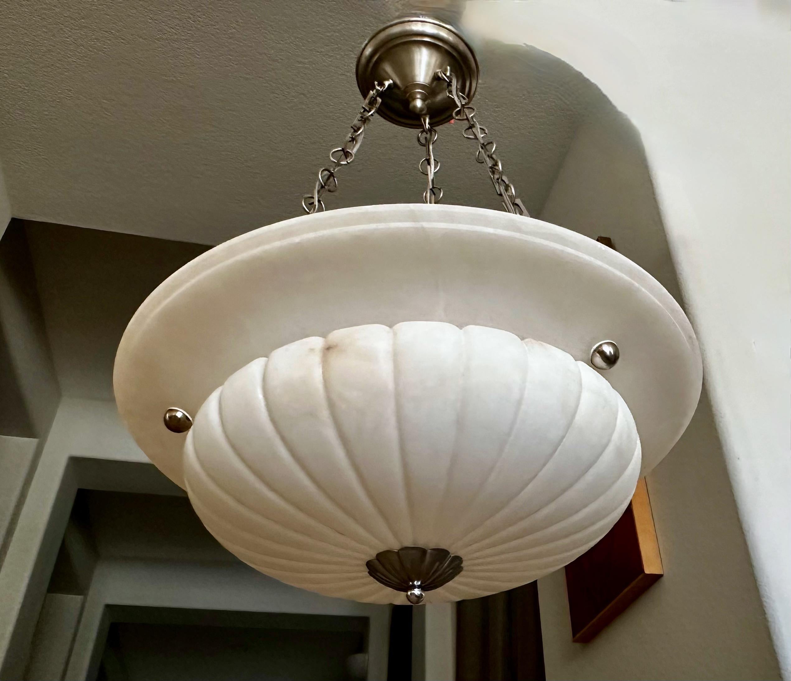 Carved alabaster pendant light or chandelier with aged patinated nickel steel fittings in the Directoire style. Newly wired for US, fixture uses three regular base size bulbs. 

Measures: Alabaster is 21.5
