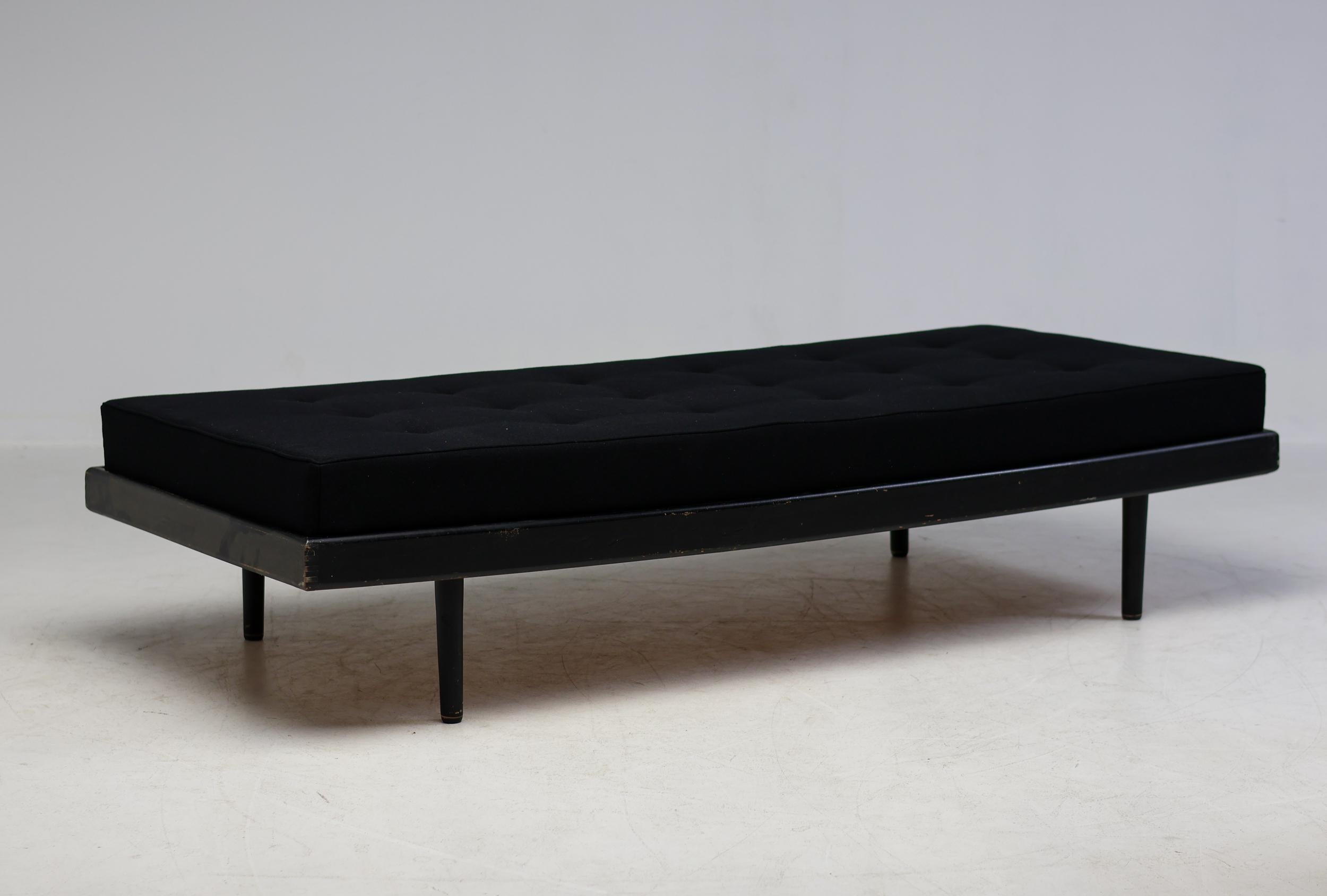 Classic modern daybed in black dye ash and plywood made circa 1960 in France.
Recent mattress upholstered in black fabric.
The edges of the ash frame have some minor scuffs as shown in the photos, the mattress was never used and is in immaculate