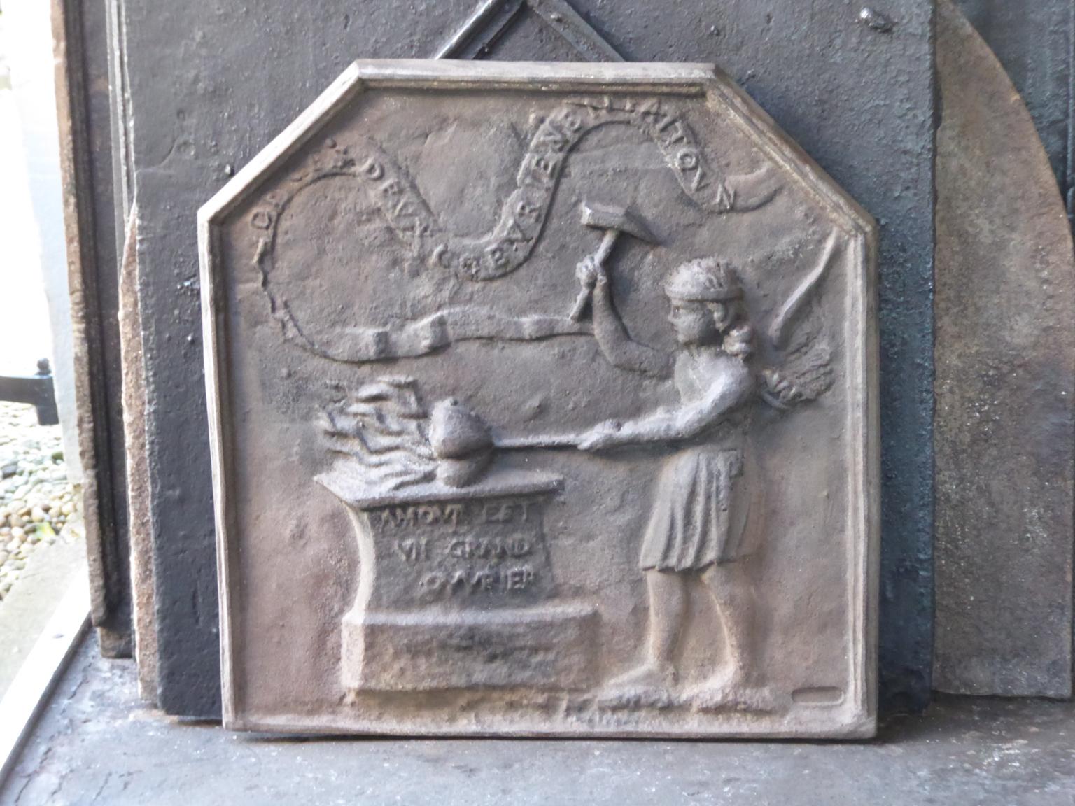20th century French fireback with an allegory of love. 

The fireback is made of cast iron and has a natural brown patina. Upon request it can be made black / pewter. The fireback is in a good condition and does not have