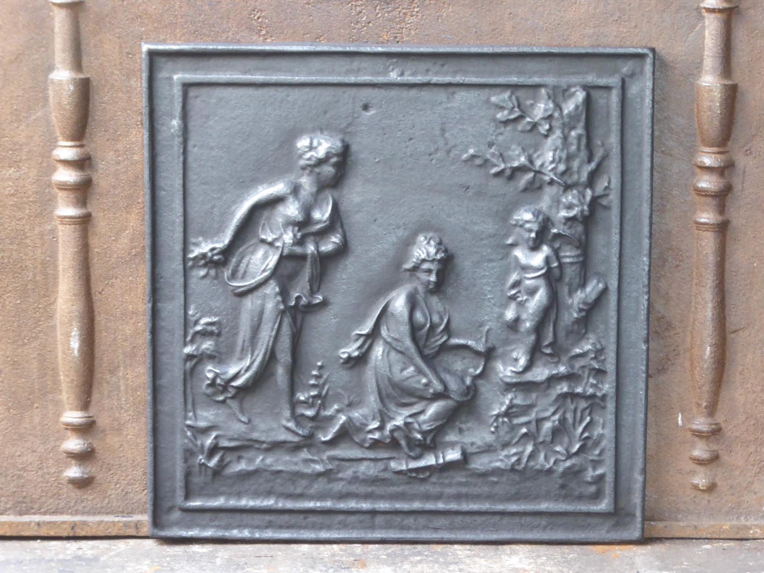 20th century French neoclassical fireback with an allegory of love. The fireback is made of cast iron and has a black or pewter patina. It is in a good condition and does not have cracks.