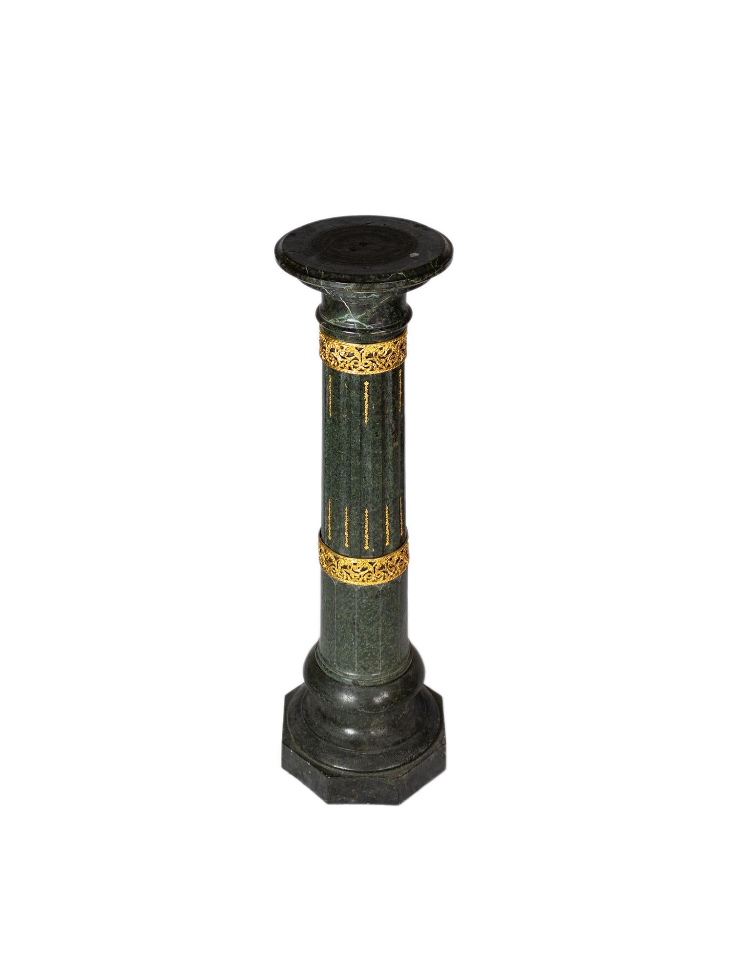 A french neoclassical 19th century alpine green marble pedestal column with gilded bronze decoration.
