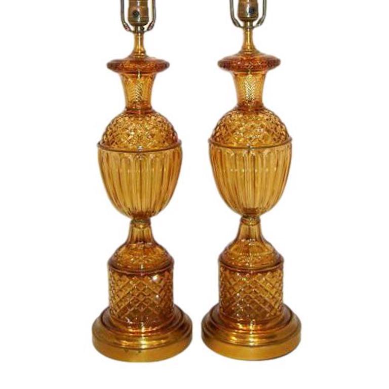 Pair of circa 1940s French molded amber glass table lamps with gilt brass bases

Measurements:
Height of body 21