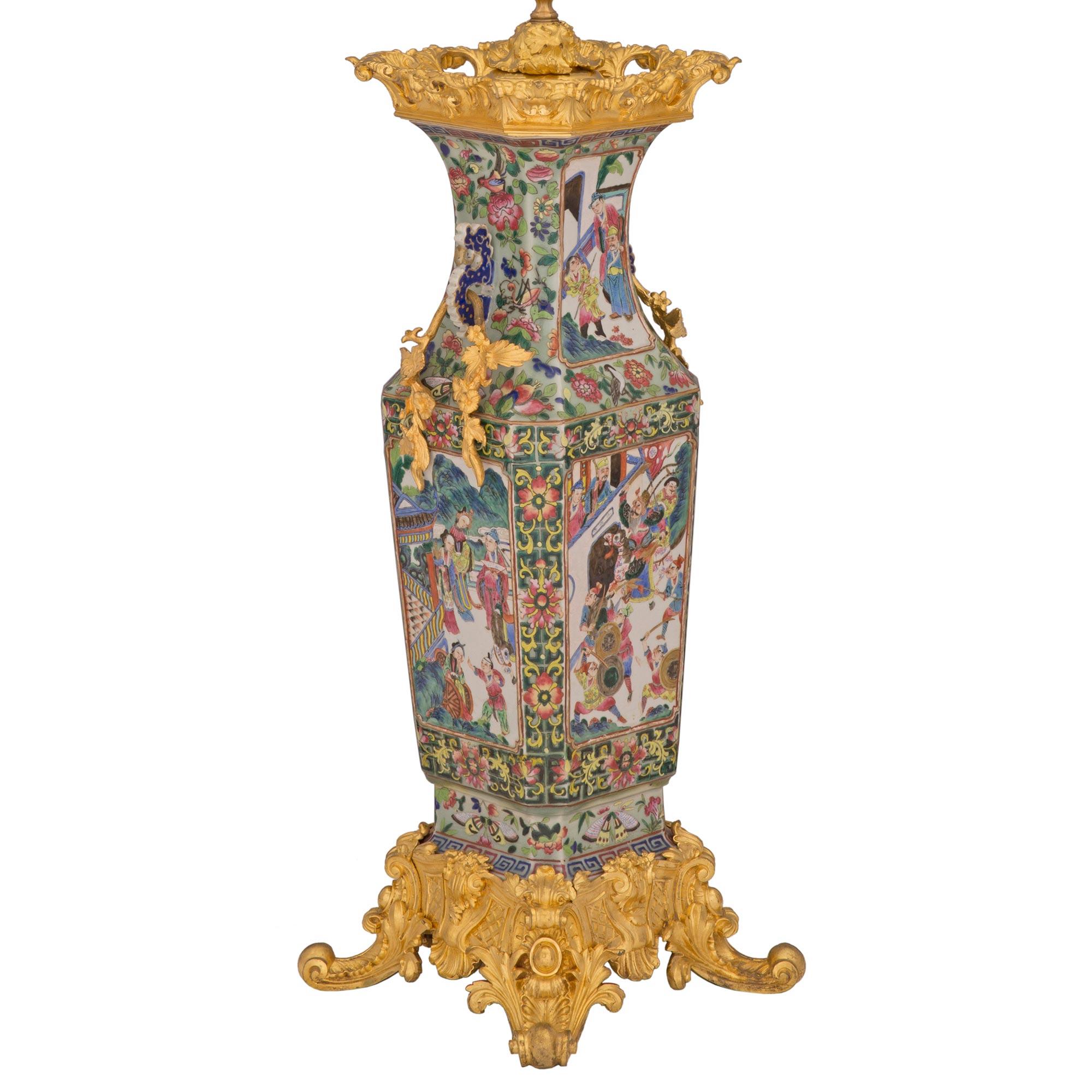 Superbe lampe de collaboration française et asiatique du 19ème siècle en porcelaine et bronze doré de style Louis XV et Famille Verte. La lampe est surélevée par une belle base feuillue et richement ciselée, ornée de cabochons, de feuilles d'acanthe