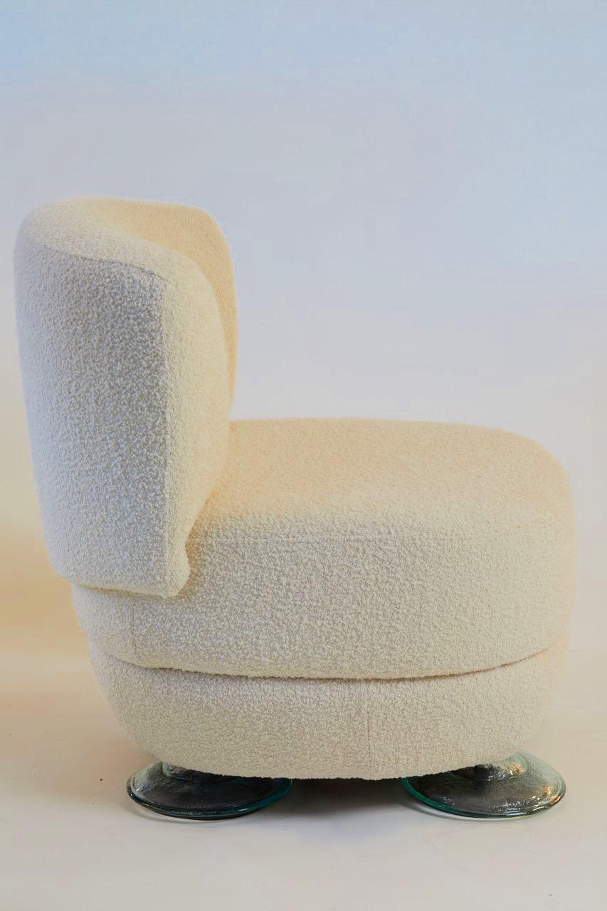 French Andrée Putman restored and reupholstered Pierre Frey ivory bouclé chair from Hotel Pershing Hall Paris, with documentation. Glass circular feet complete the unique design, circa 2001.