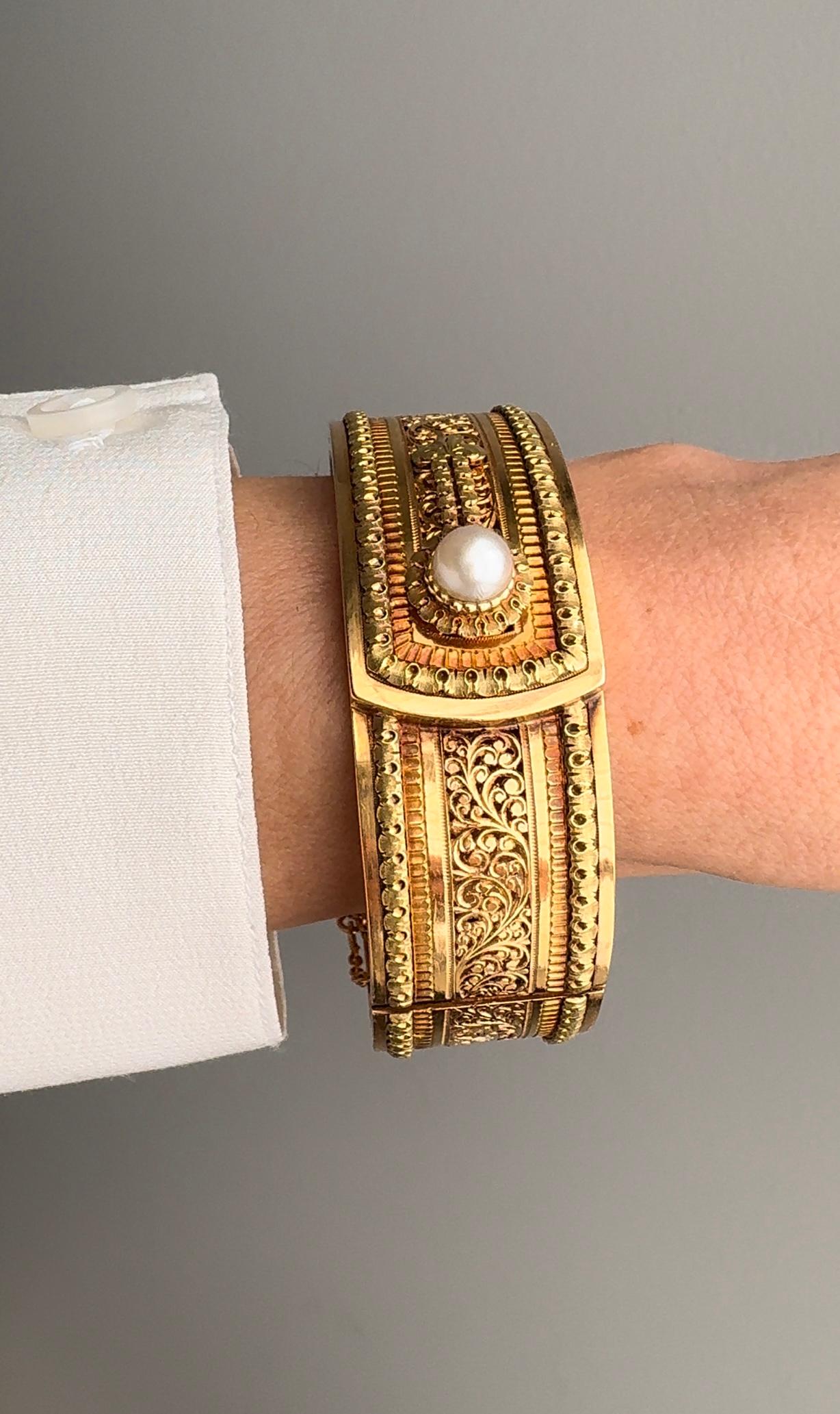 A fanciful lace and natural pearl button cuff bangle by Auguste Lahaye (workshop later purchased by the esteemed French jeweler Rene Boivin). Masterfully hand fabricated in contrasting rose and yellow 18k gold with a delightful patina. The entire