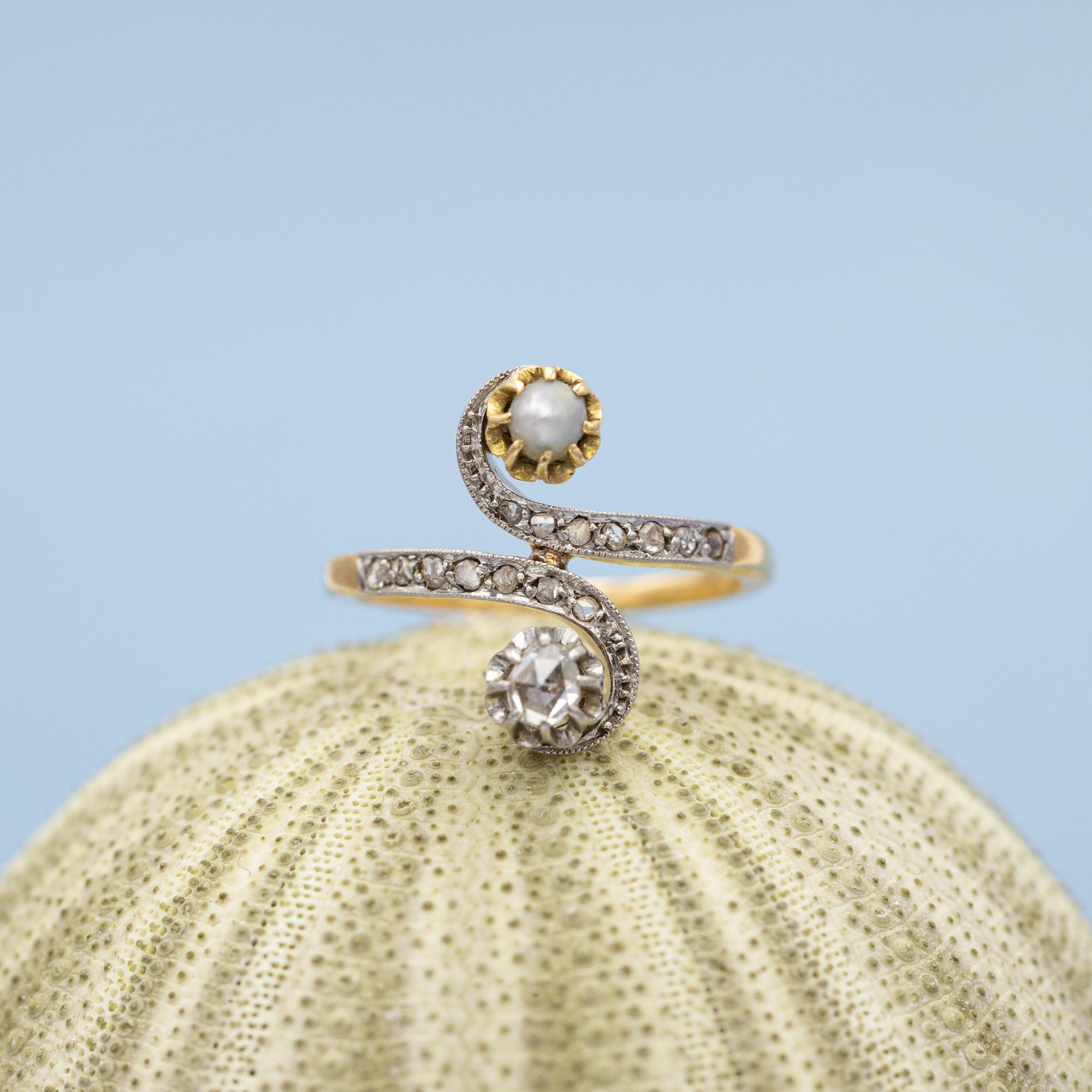 This extraordinary French ring is crafted in 18 karat yellow gold and finished with white rhodium, like mostly done with antique rings crafted around this late victorian era. This stunning 'toi et moi' -ring is set with a lovely old rose cut diamond