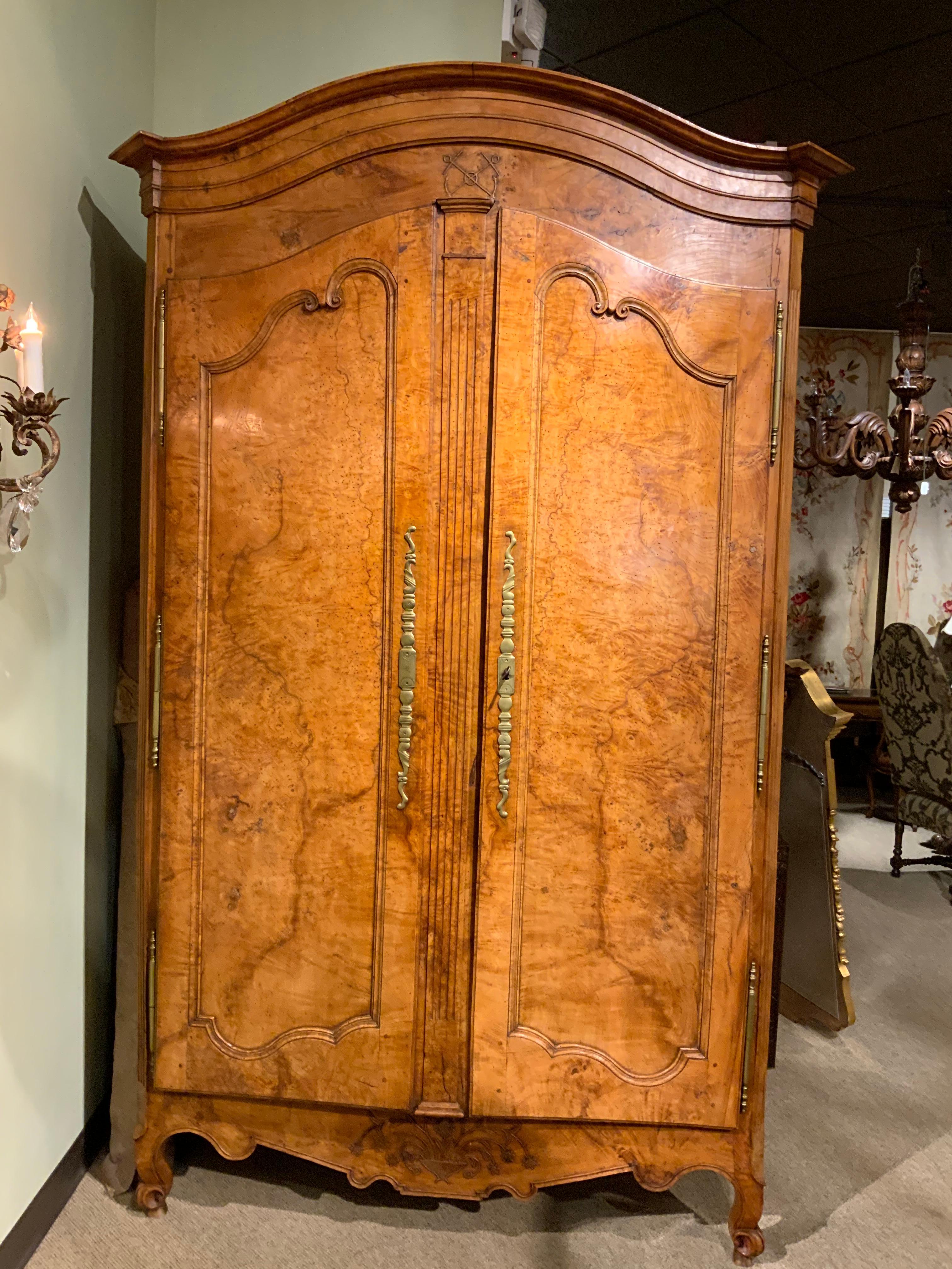 Antique rustic armoire with doors that open wide. Original hardware and locks.
The crest has a domed shape and beneath very good carvings of crossed
Anchors. Three sturdy shelves that will accommodate good storage.
Floral and foliate carvings