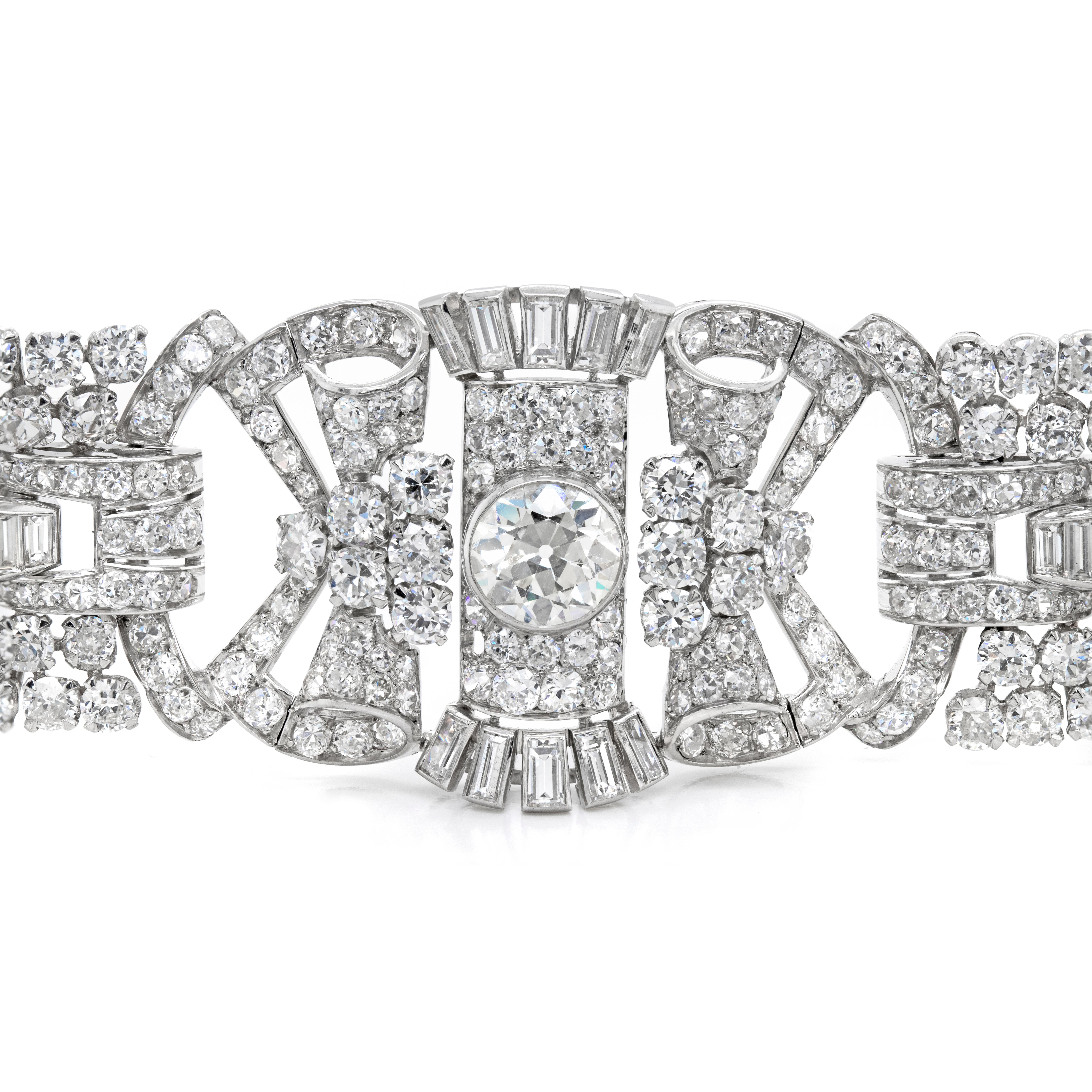 An exceptional handmade 1920's Art Deco bracelet set with a grand total of 573 diamonds totaling to an impressive approximate weight of 42.00 carats. This beautiful piece features 3 larger rubover set old cut diamonds on 3 links, with the centre