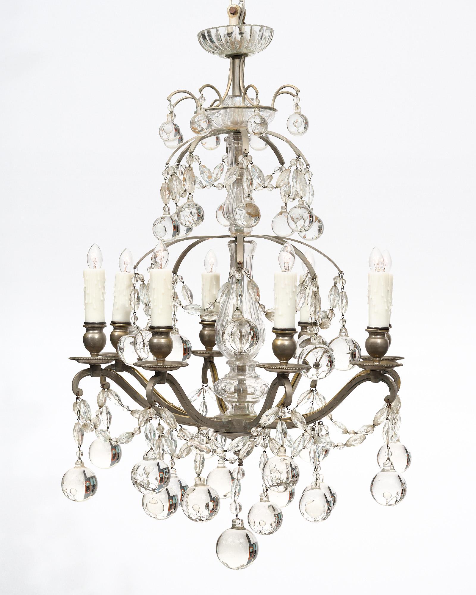Chandelier from France by Baccarat. This fixtures features glass crystal adornment and spheric drops. The structure is pewter. It has been newly wired to fit US standards.
The current overall height is 48.75
