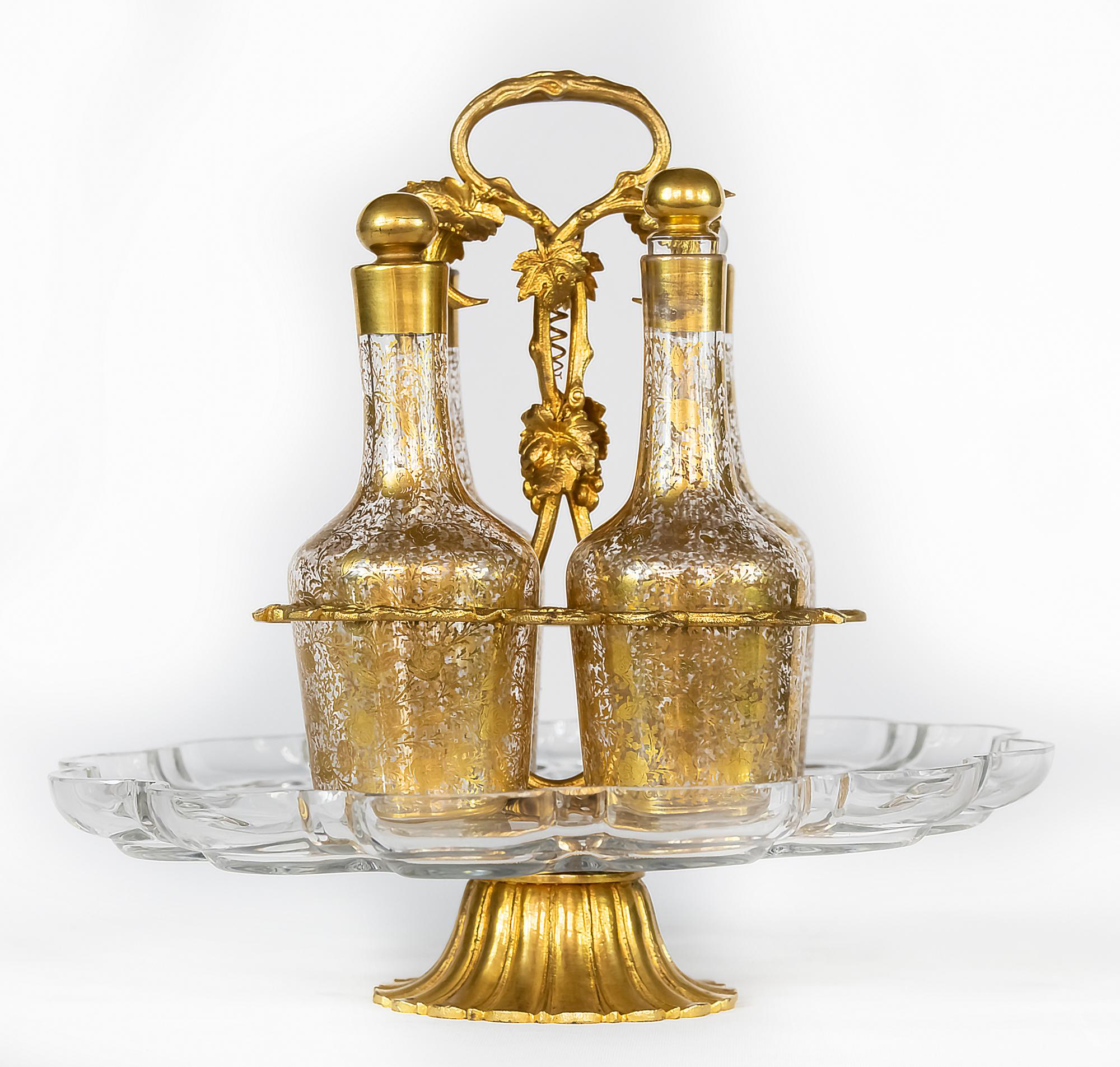 Antique French liqueur crystal and gilt bronze stand carousell carafe/decanter set.
The bronze holder is decorated with leaf elements and completed with crystal tray including 4 pcs. of crystal carafes.
Very good antique condition.