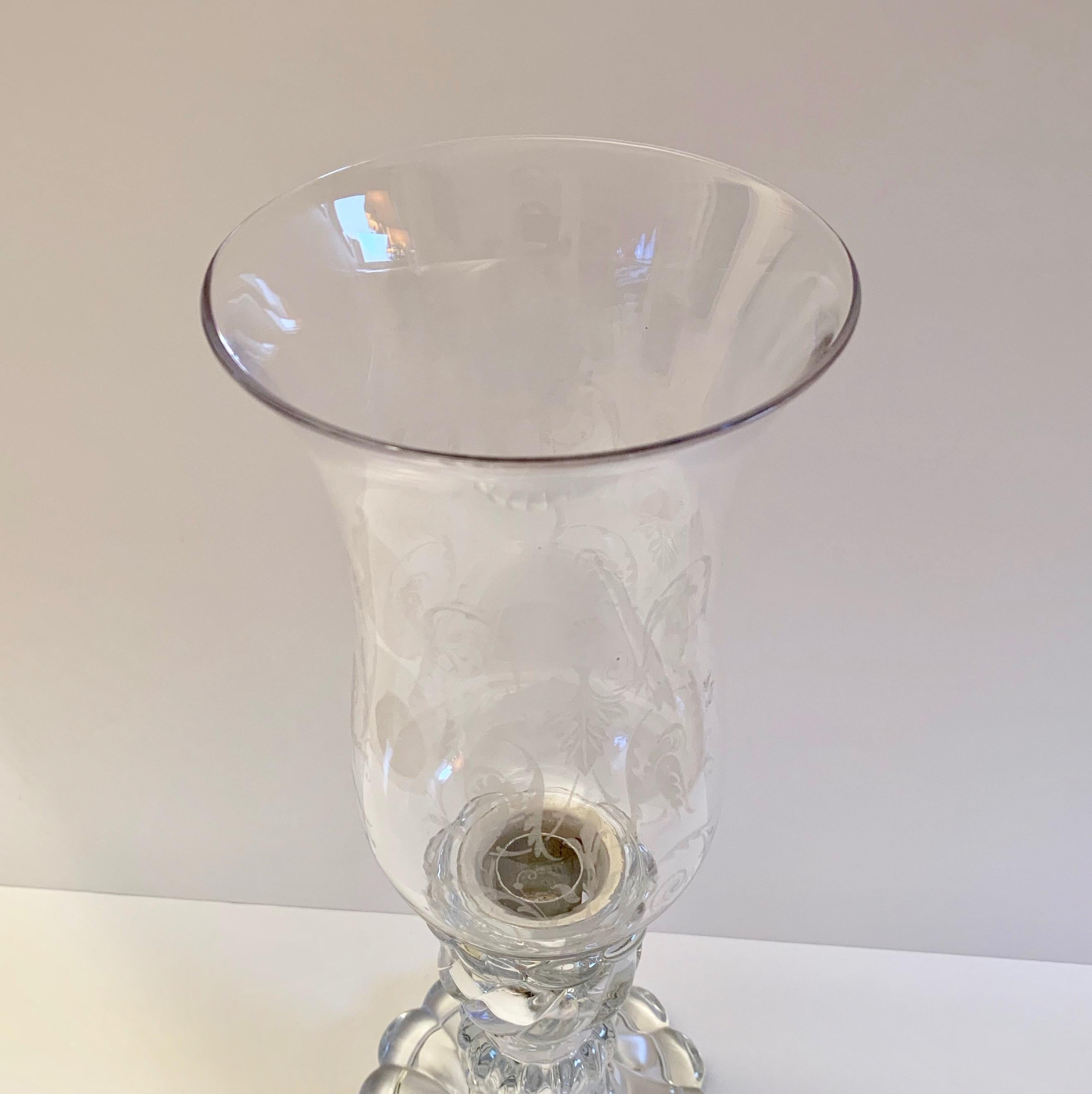 A single Baccarat candleholder in bamboo swirl design with an etched glass storm shade.
Please note that the storm shade is not from manufacture Baccarat and only the stand is. The storm shade has been specially modified in order to fit the