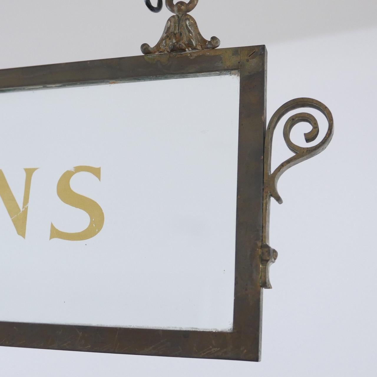 Hanging glass and bronze decorative signs.

Believed to be from a stock exchange or bank perhaps. The original sign writing is retains but could be replaced and have new sign writing done with any text suitable for its new use.

One states