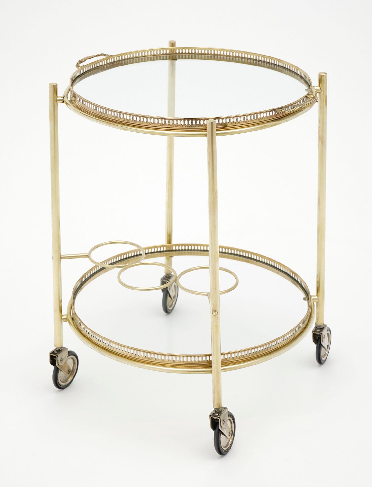 Bar cart in gilt brass, French, featuring a detachable tray up top and a bottle holder off the bottom. We love the scale of this piece - perfect for serving drinks!