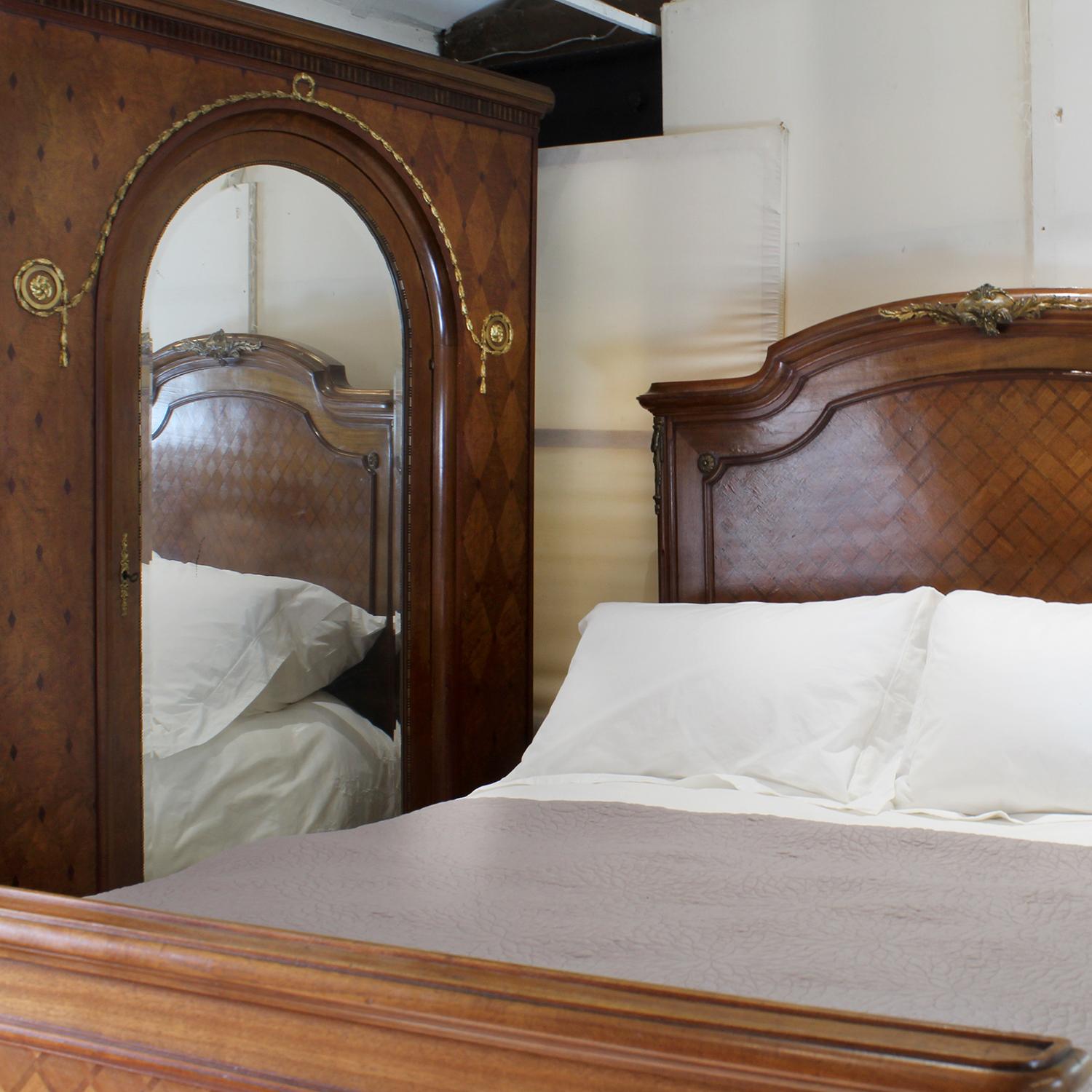 An attractive French antique bed with inlaid fruitwood parquetry panels, elegant shape and ormolu decoration, and similar wardrobe by Mercier of Paris.

This bed accepts a US Queen Size (or UK King Size), 5ft wide (60 in), base and mattress