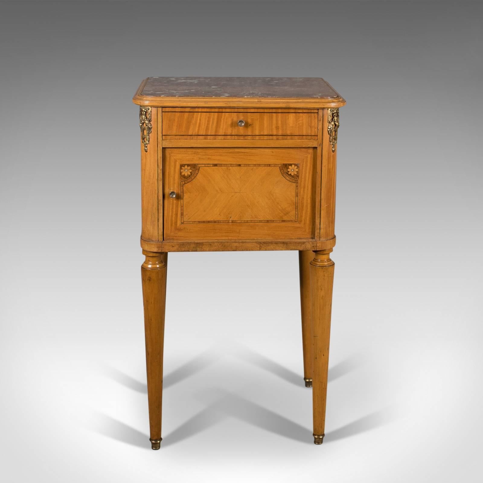This is a French antique bedside cabinet, a marble top nightstand dating to the late 19th century, circa 1890.

Appealing biscuit tones to the light walnut finish
Attractive grain in the quartered veneered decoration
Well veined blush marble top