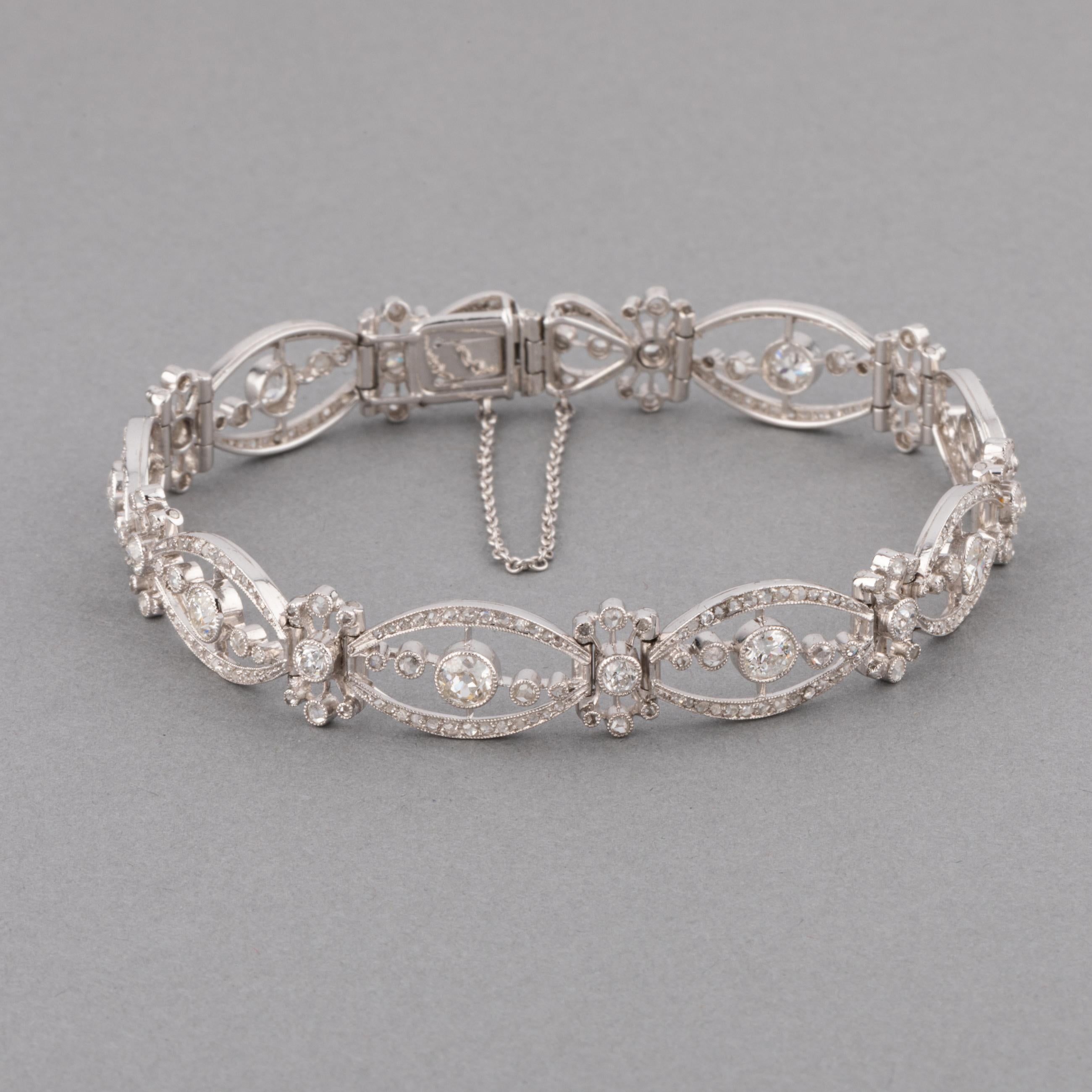 A very beautiful antique bracelet, made in France circa 1910.
Made in white gold 18k and set with old European cut diamonds. The width is 9mm, the length is 17.5 cm. The bigger diamonds weights 0.20 carats each.
Total weight: 17.90 grams

