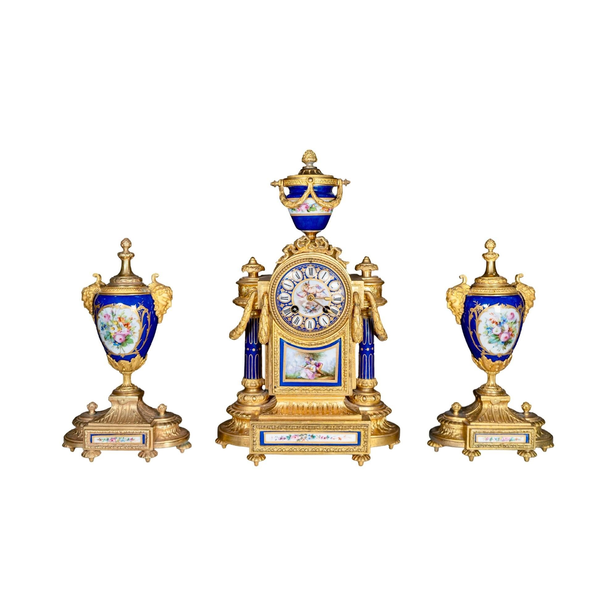 A magnificent late 19th-century garniture clock set in the Sèvres style, crafted from gilded bronze and porcelain. Originating from France, this exquisite set includes a finely detailed clock and two lidded urns, each adorned with hand-painted