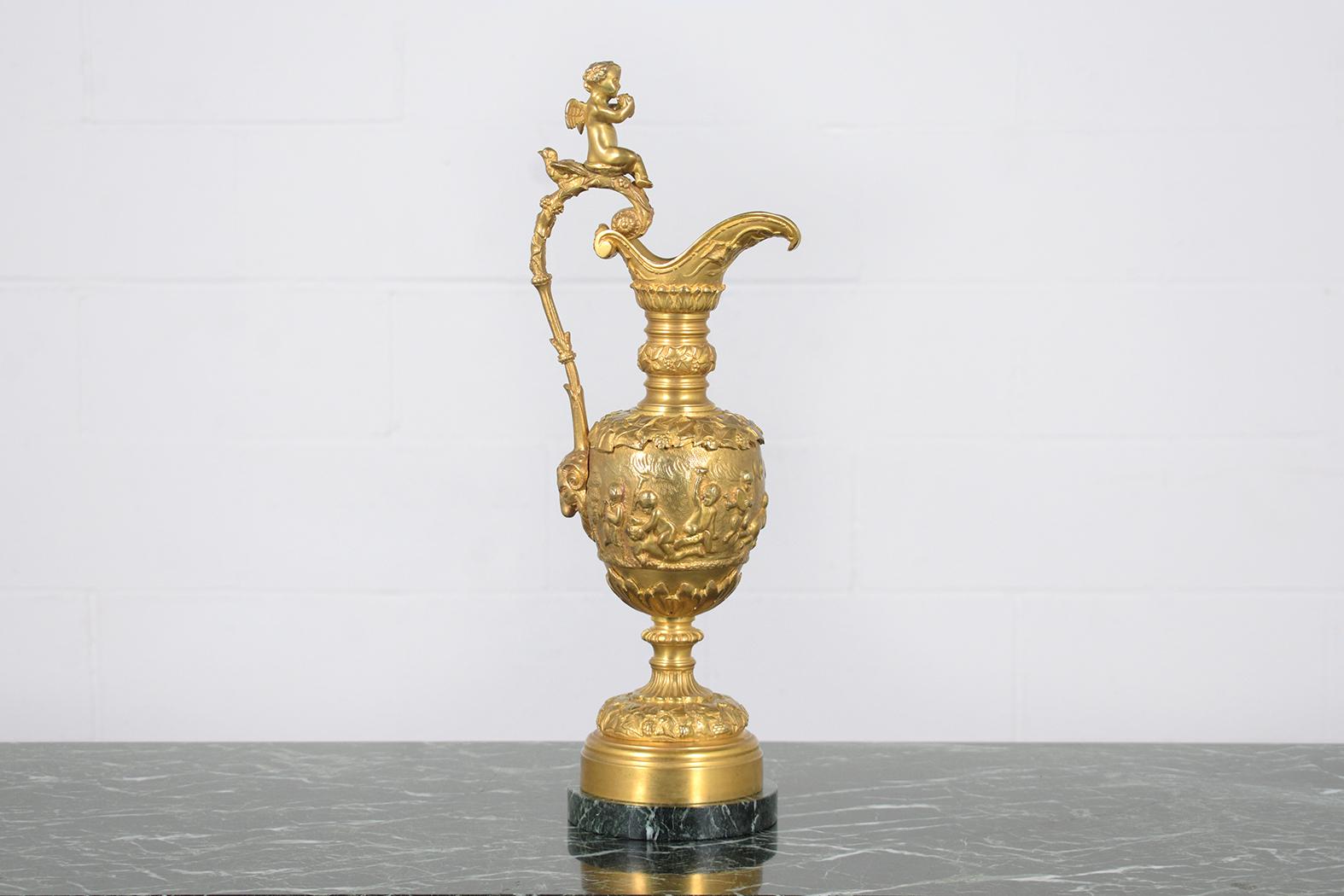 This extraordinary French antique urn is a striking piece, expertly crafted from a combination of bronze and marble and preserved in great condition. Dating back to the early 1900s, this urn showcases unique carving motifs throughout, embodying