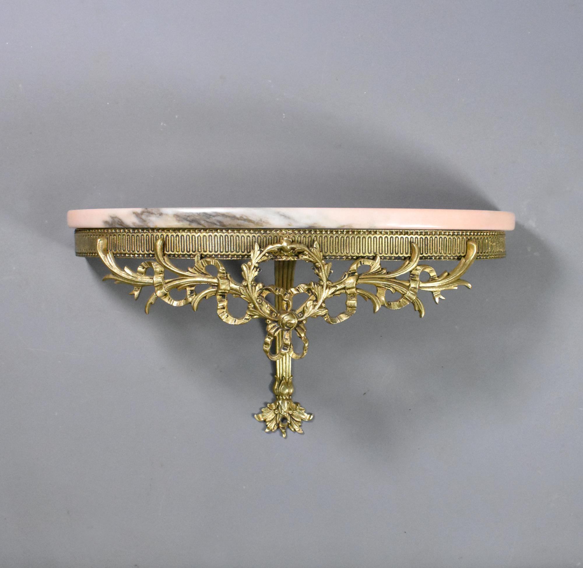 French Antique Bronze and Marble Wall Console Louis XVI Style 19th Century
 
A delightful bronze and marble wall console featuring a pink variegated demilune top.
 
The marble sits on a finely decorated bronze support with a curved central arm
