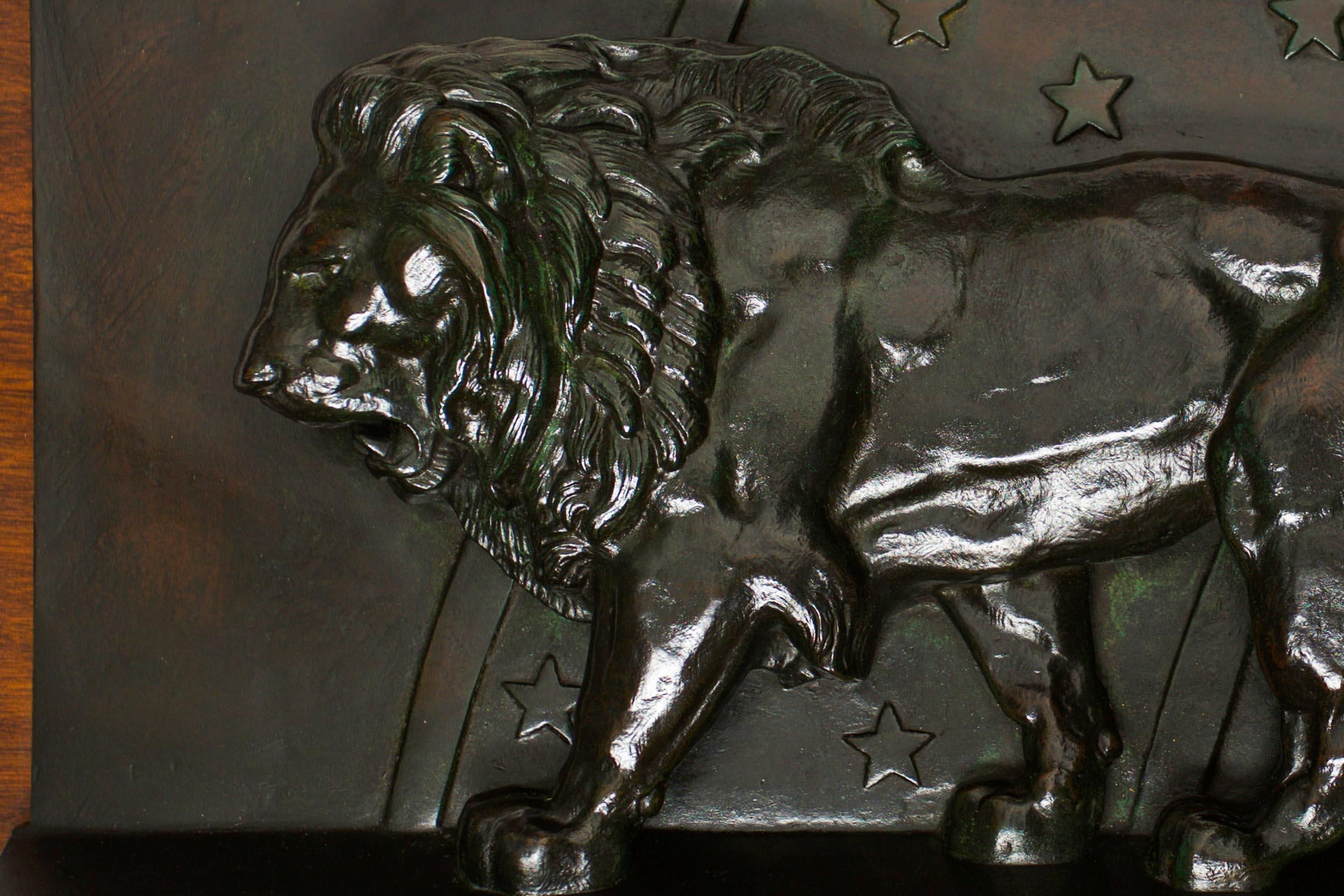 THE LION OF THE JULY COLUMN: LION OF THE ZODIAC

AFTER A MODEL BY ANTOINE-LOUIS BARYE

Patinated bronze on walnut plaque  Signed 