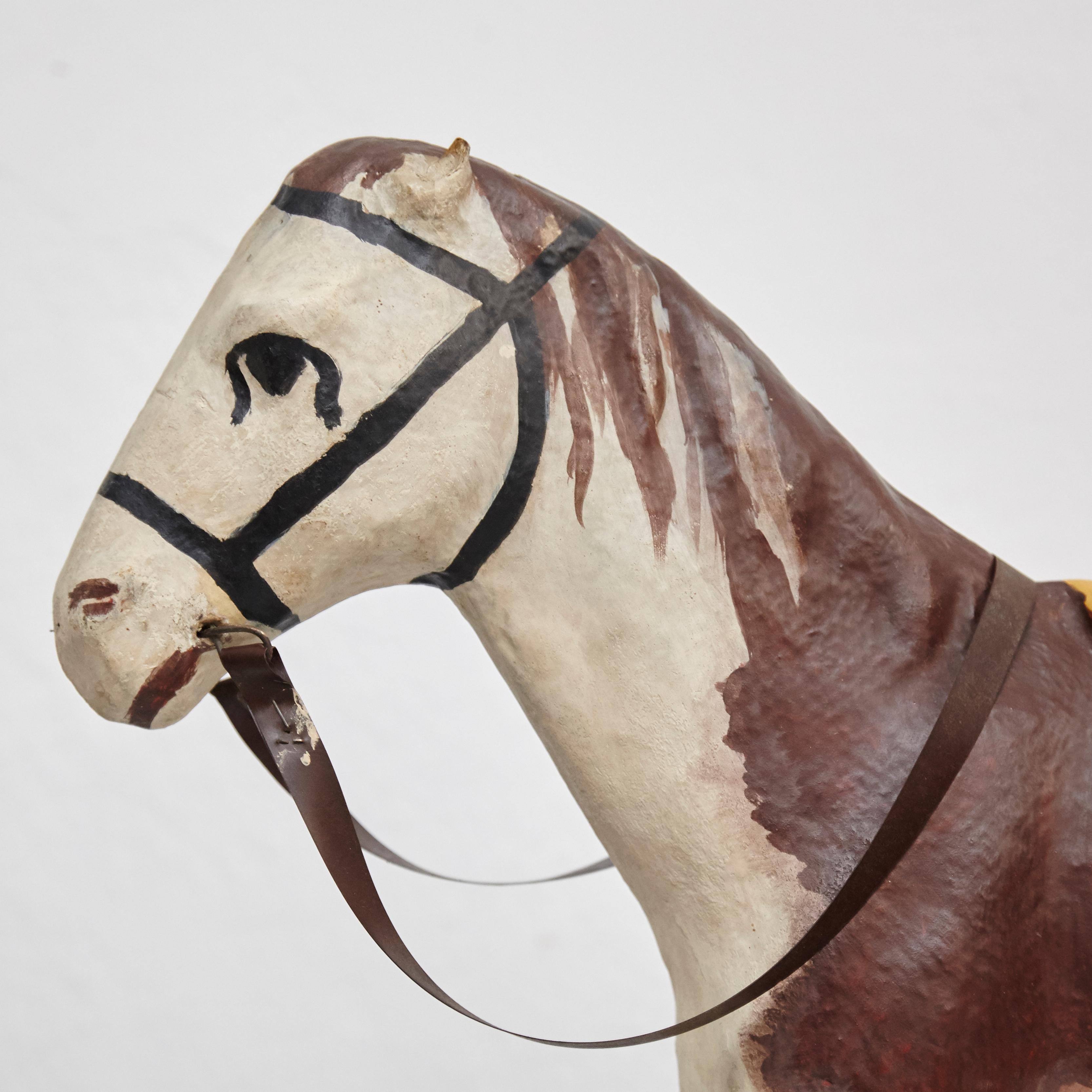 Antique cardboard children's horse.
By unknown author, France, circa 1950.
In original condition, with minor wear consistent with age and use, preserving a beautiful patina.

Materials:
Cardboard
Metal wheels

Dimensions:
D 58 cm x W 18 cm