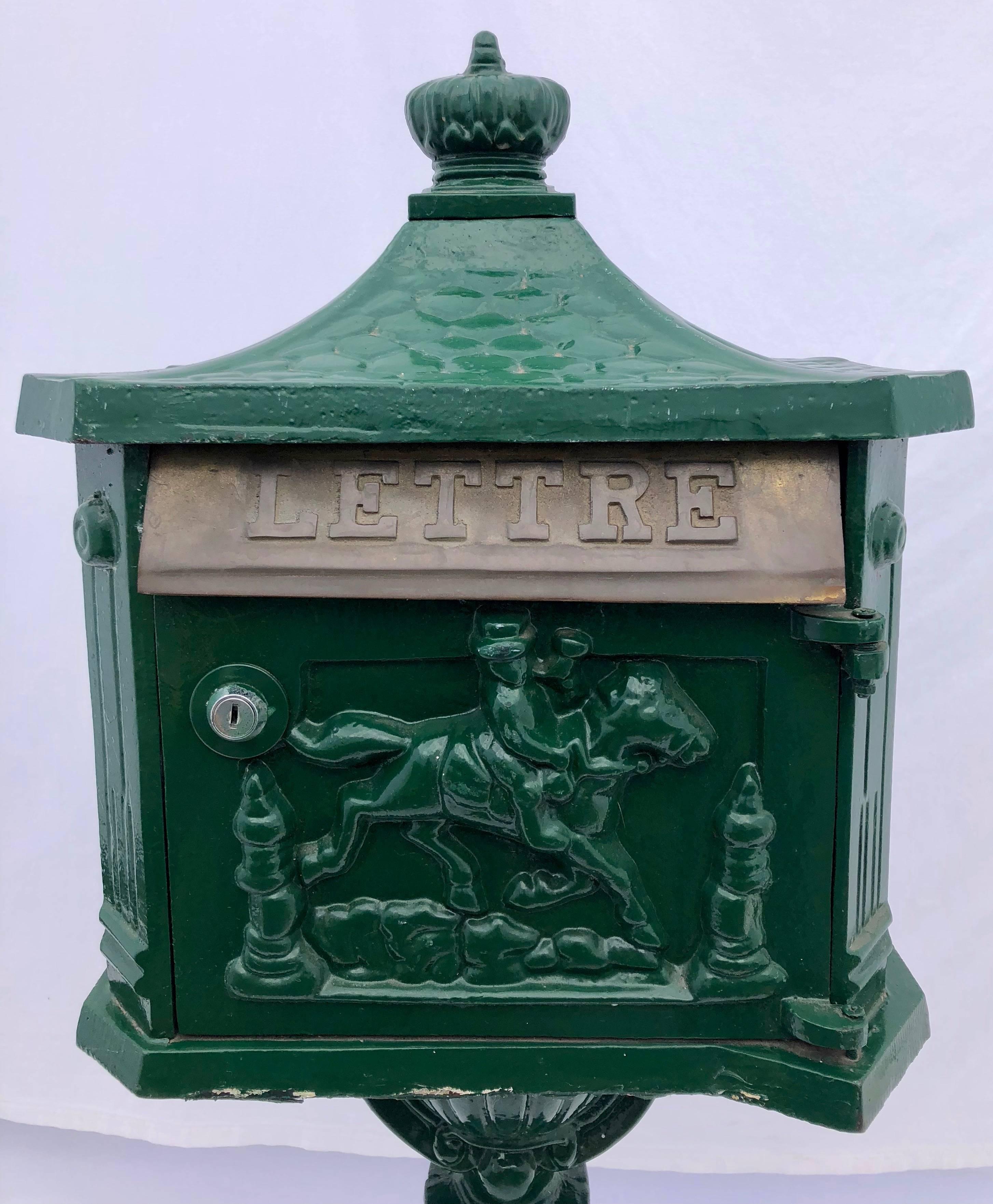 This is a beautiful French cast iron standing mailbox painted in green. In the front there is a mail slot for letters marked in French 