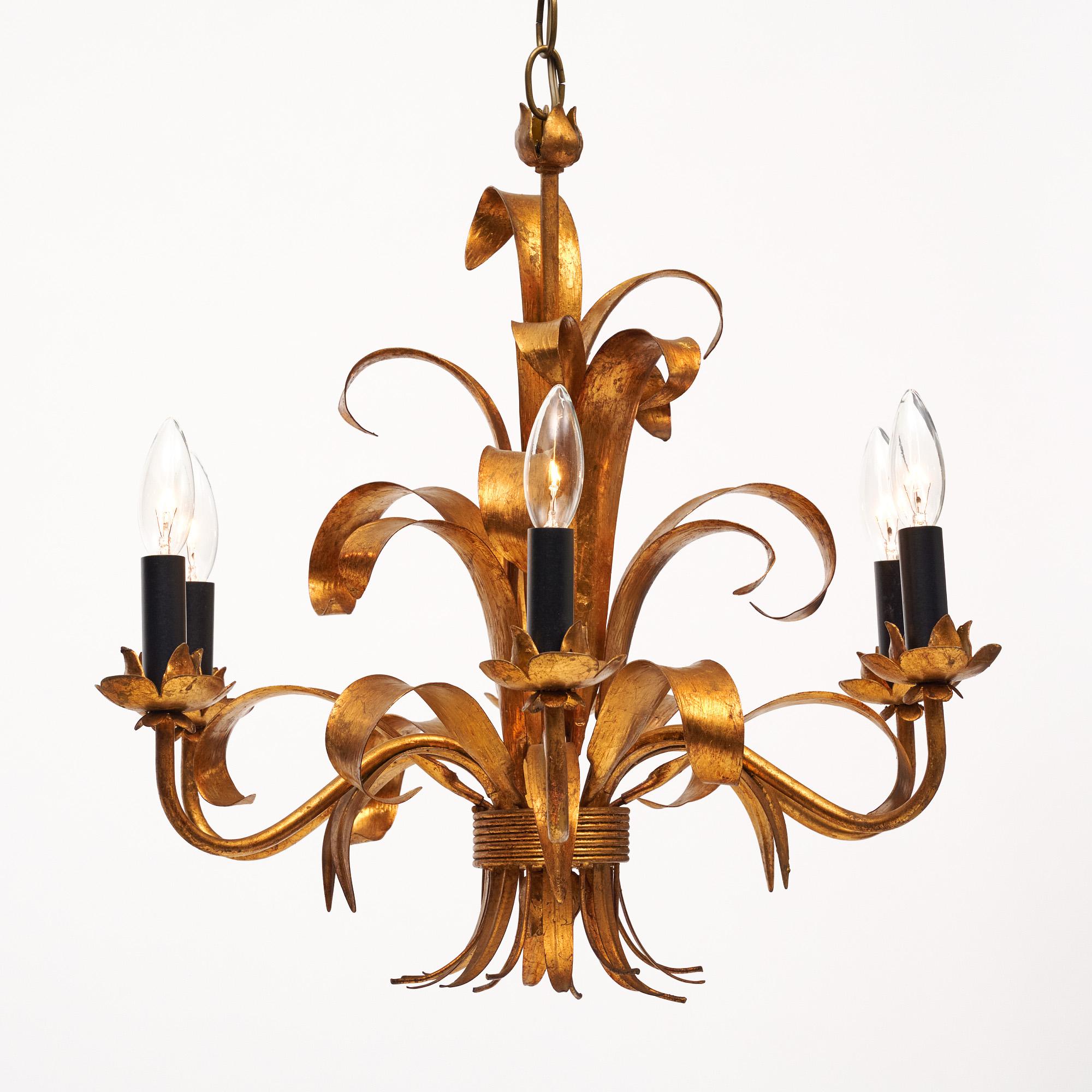 Chandelier from France made of “tole” metal that has been finished with a vibrant gold leaf. There are six arms and a rich array of stylized. It has been newly wired to fit US standards. The chandelier is in very nice antique condition with only