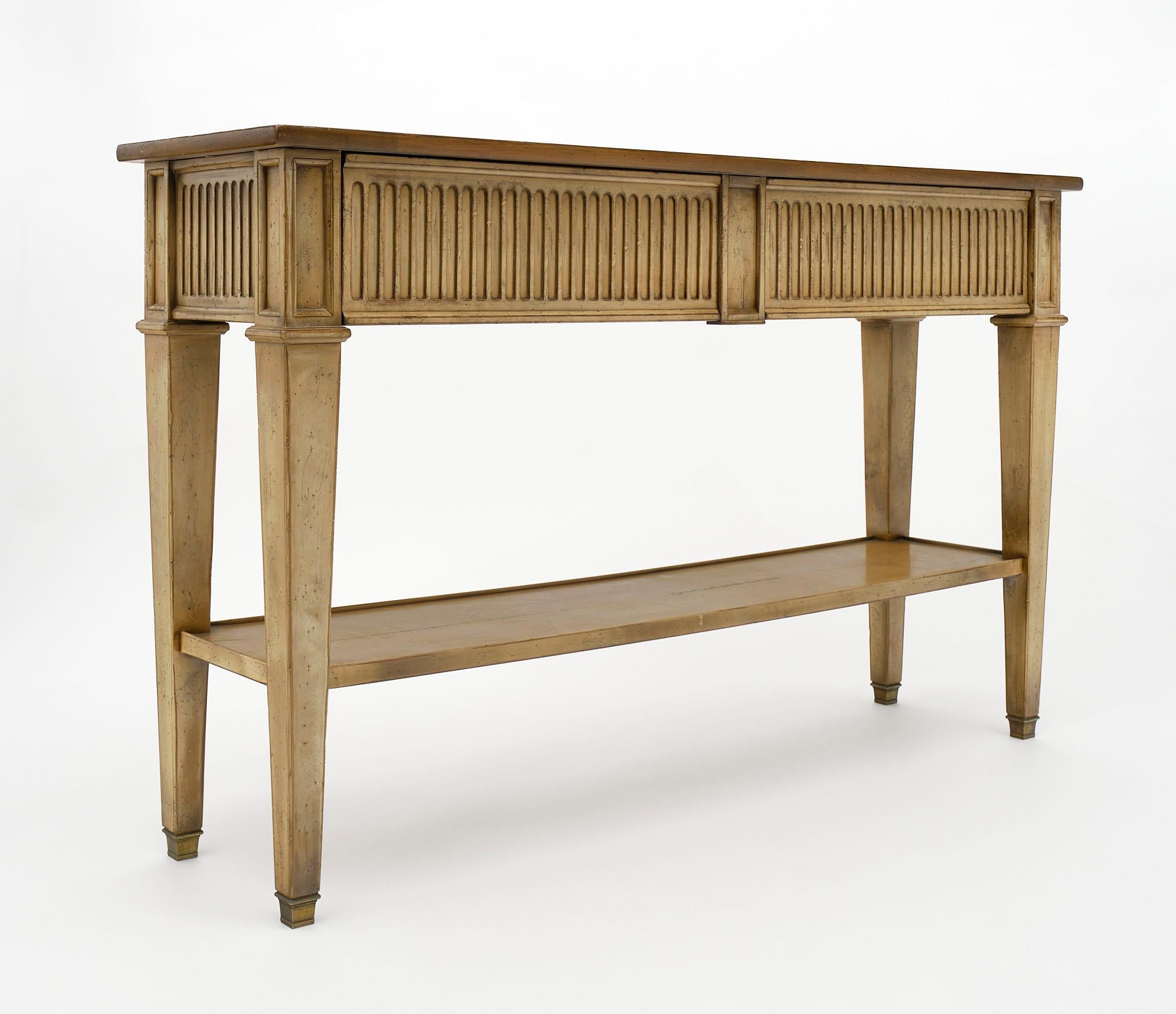 Console from France made of hand-carved wood; painted and patinated. There are two dovetailed drawers and a bottom shelf.