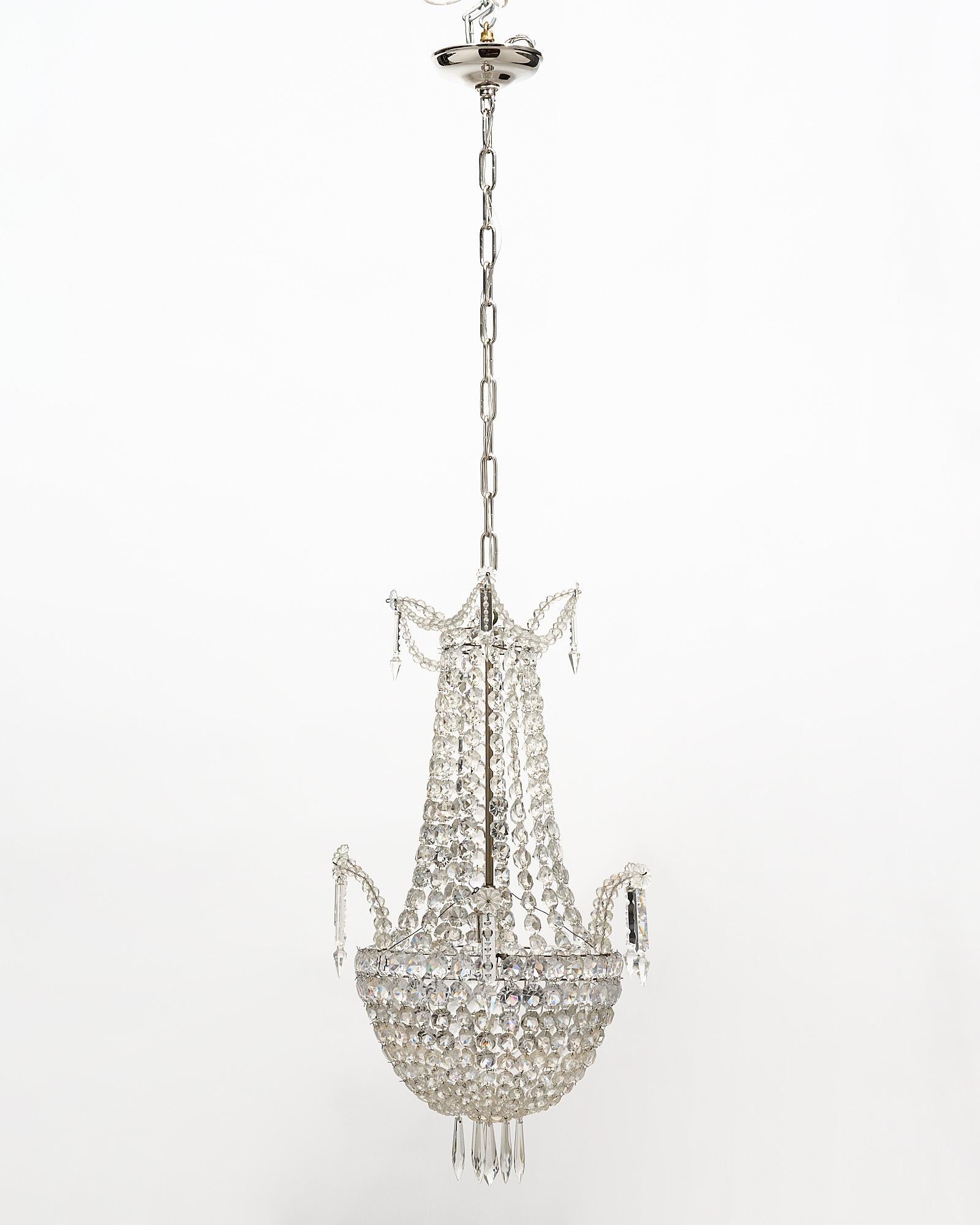 Chandelier, French, by Baccarat with the original cut crystals and pendants.
The current height from ceiling is 52