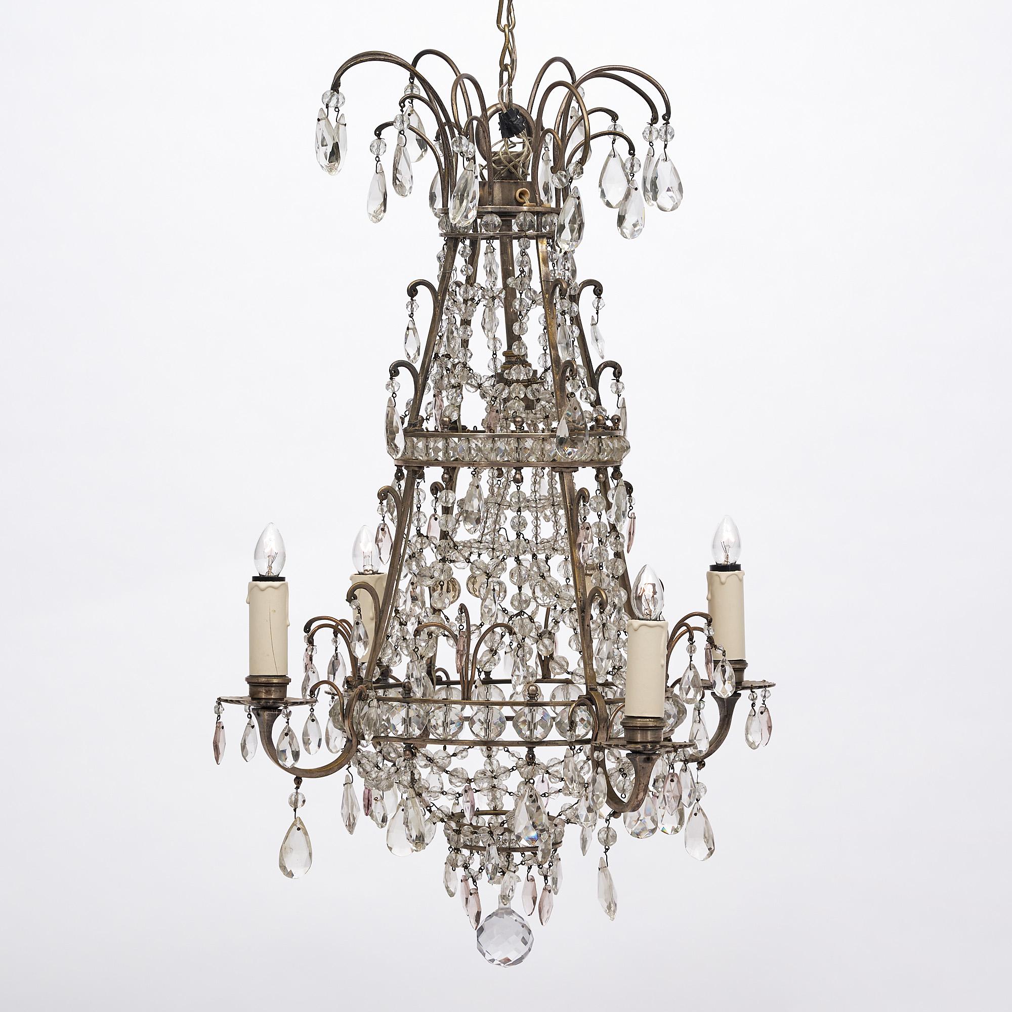 Chandelier with four branches from France. This fixture features a silver plated structure with multiple cut crystals and pendants interlaced with rows of cut beads. It has been newly wired to fit US standards.