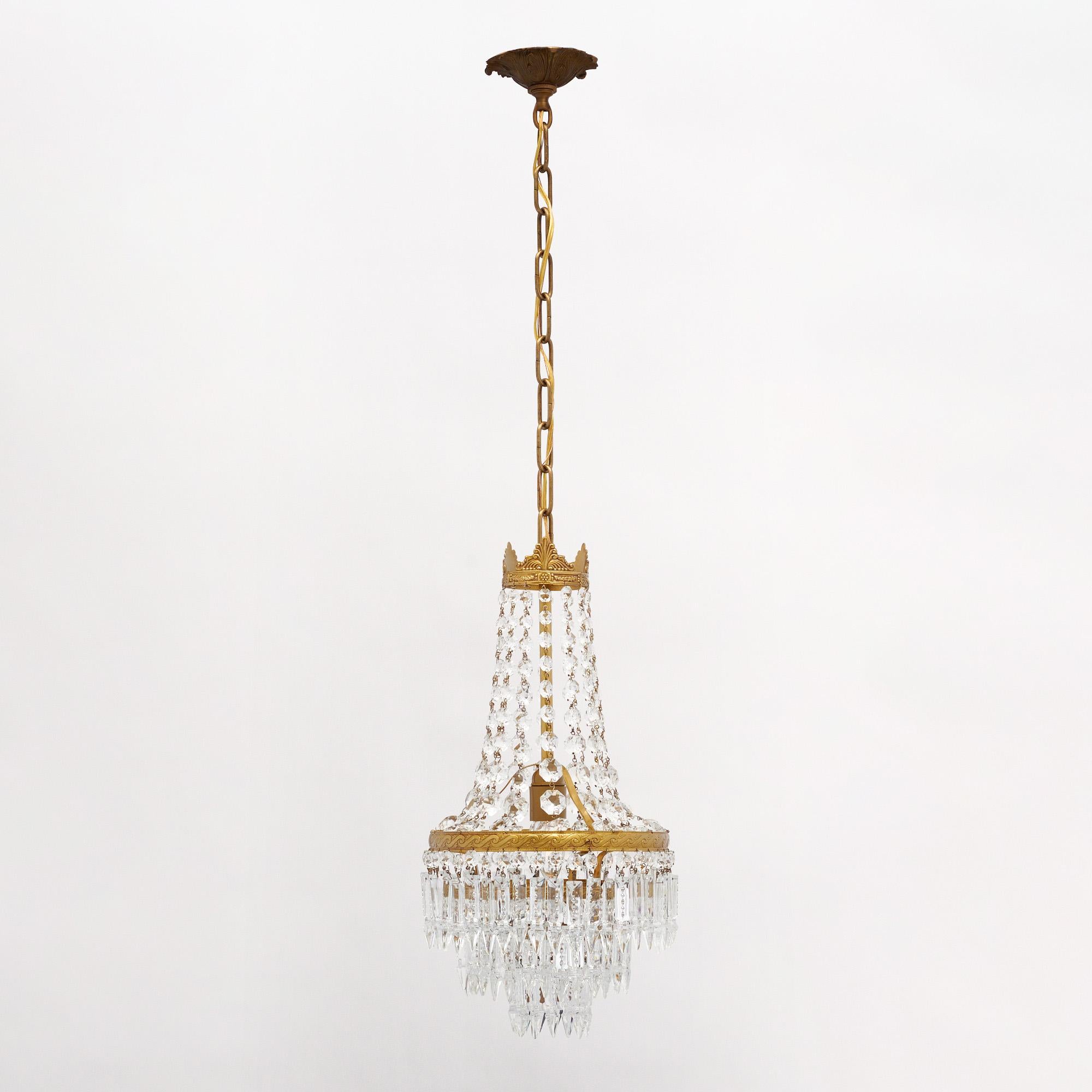 Lustre ancien de France composé d'éléments en cristal taillé, de cabochons et de pendentifs. Ils sont présentés sur une structure en laiton. Il a été nouvellement câblé pour correspondre aux normes américaines et est en très bon état antique avec