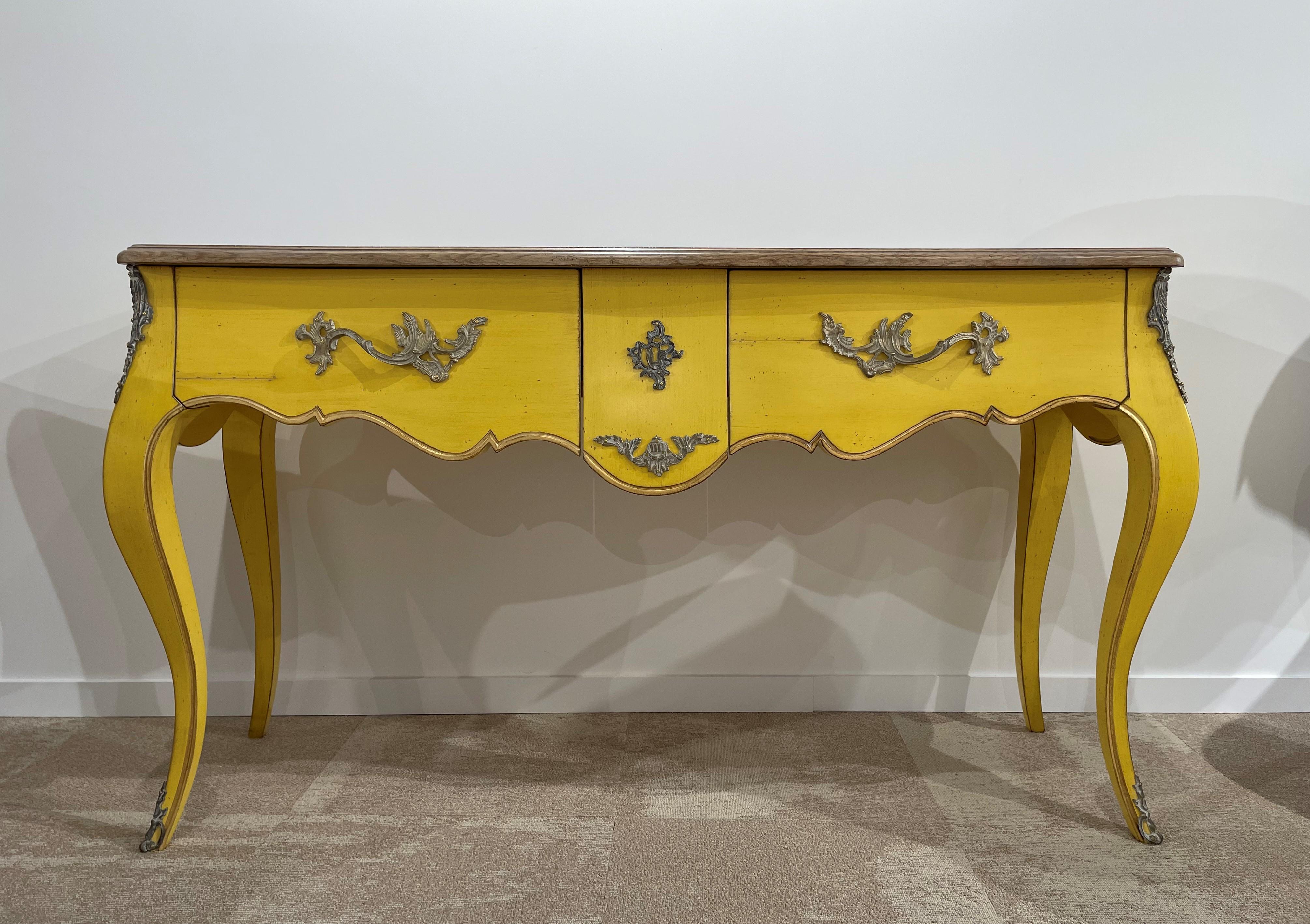 French antique design and Louis XV style wooden and brass console table composed of a solid wood structure yellow patina with solid wood top and brass finishes.