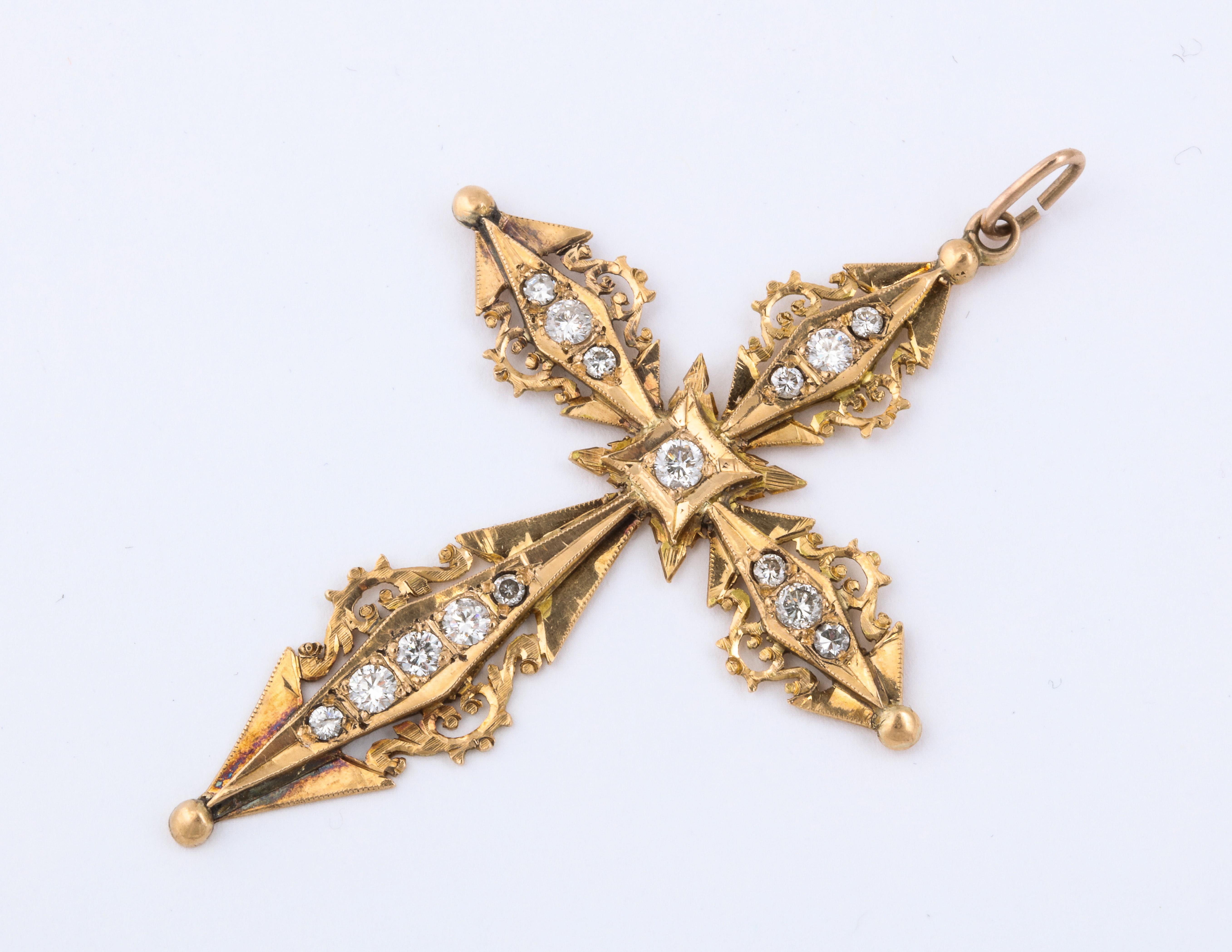 A stunning French Antique Diamond and Gold Cross. An 18 k gold cross comprised of 15 quality diamonds set on a Art Nouveau form. An exceptional piece. 