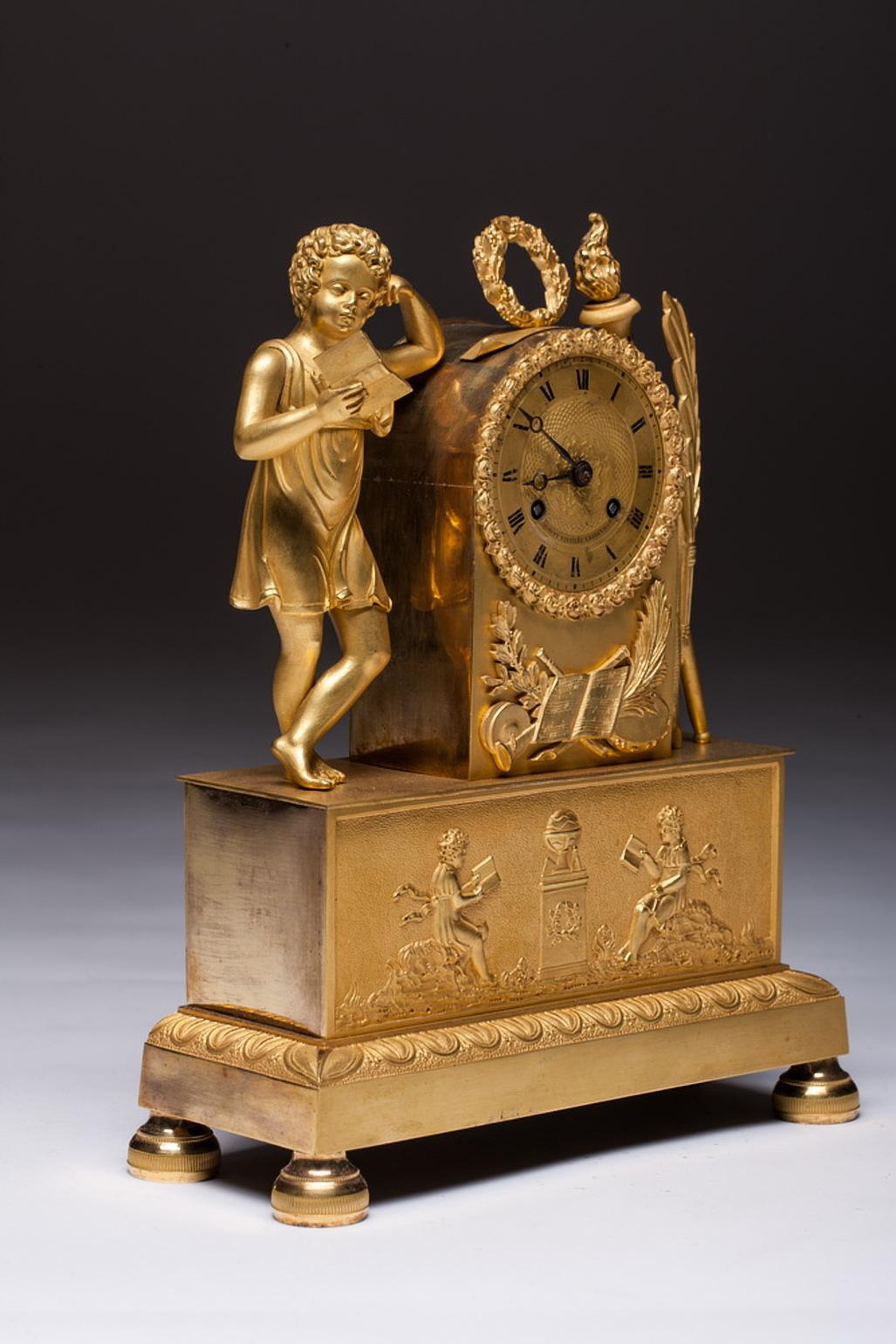A French antique Empire gilt bronze mantel clock. A clock with a neoclassical figure that symbolizes science.

A figure in one of his watches read the book of a flaming tortoise and laurel on the other side. The clock mechanism is decorated with a