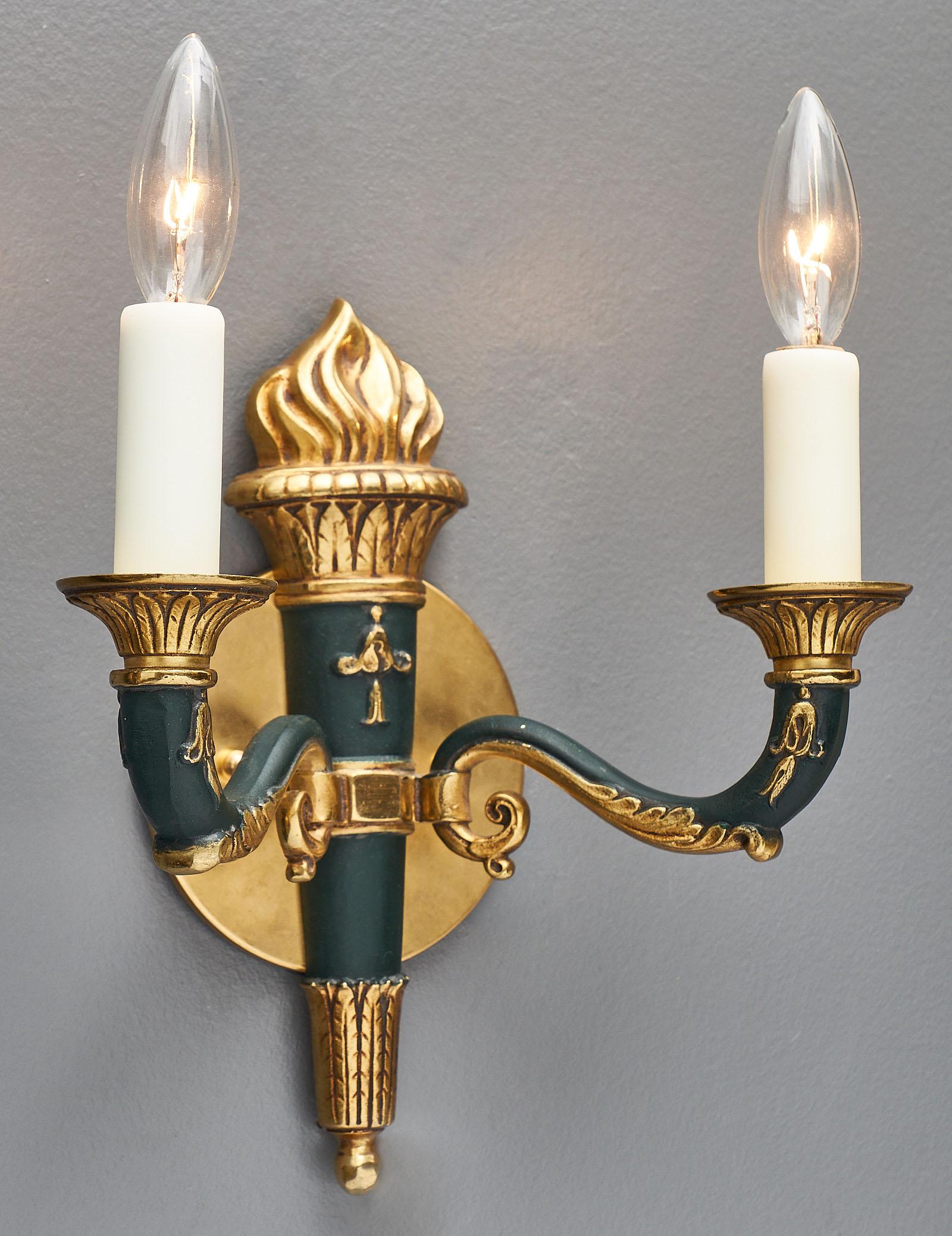 A finely cast pair of French Empire style antique sconces. The elegant finish combines gilt bronze of a very high quality with dark green lacquer. We love the Classic sophistication of this pair. They have been newly wired to fit US standards.