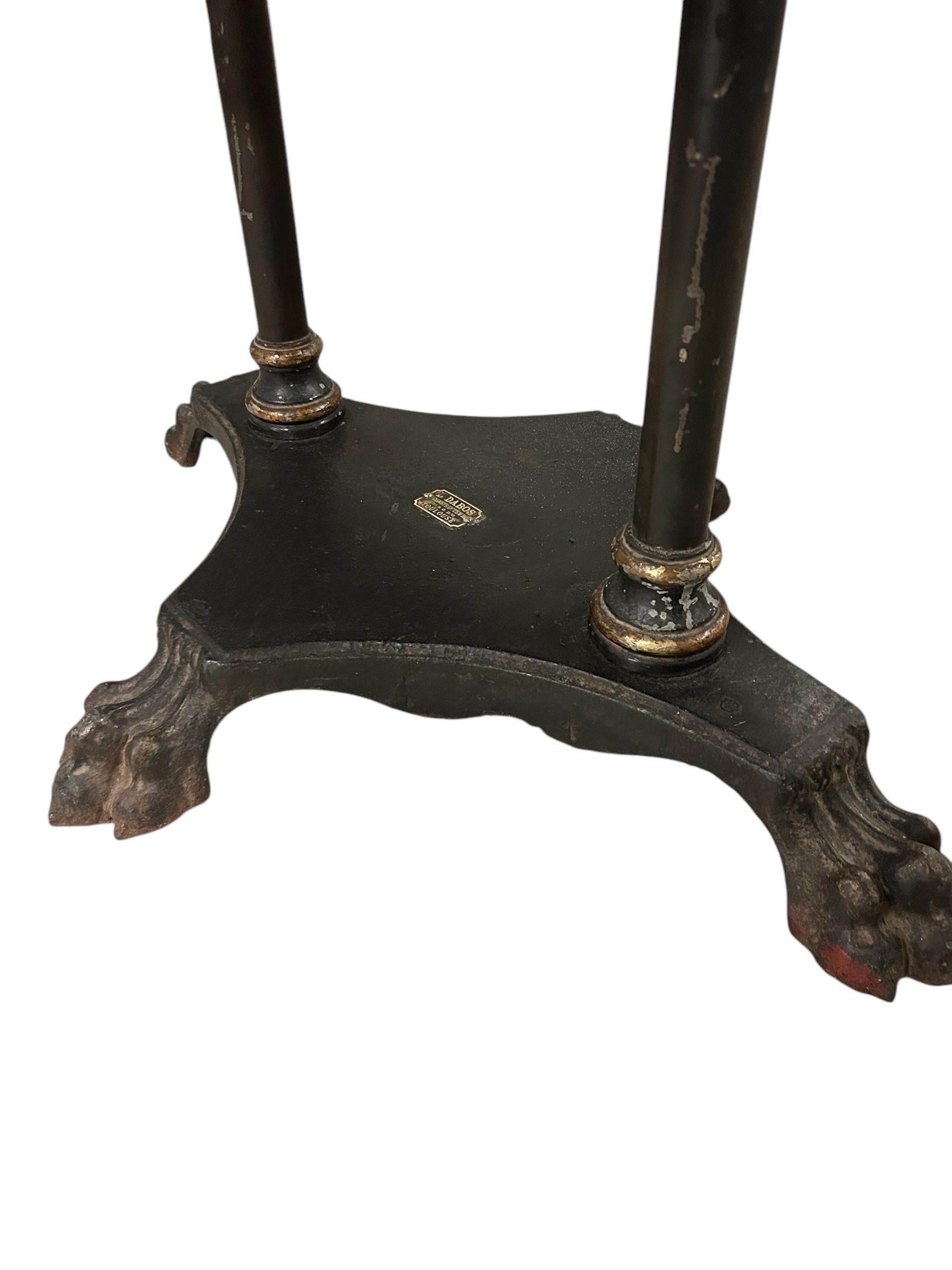 An incredible antique etagere or display case manufactured in Toulouse, France over 100 years ago. Made by L. Dabos of cast iron, wood and brass fittings. A brass tag from the company L. Dabos is clearly attached. Quite possibly used as a high end