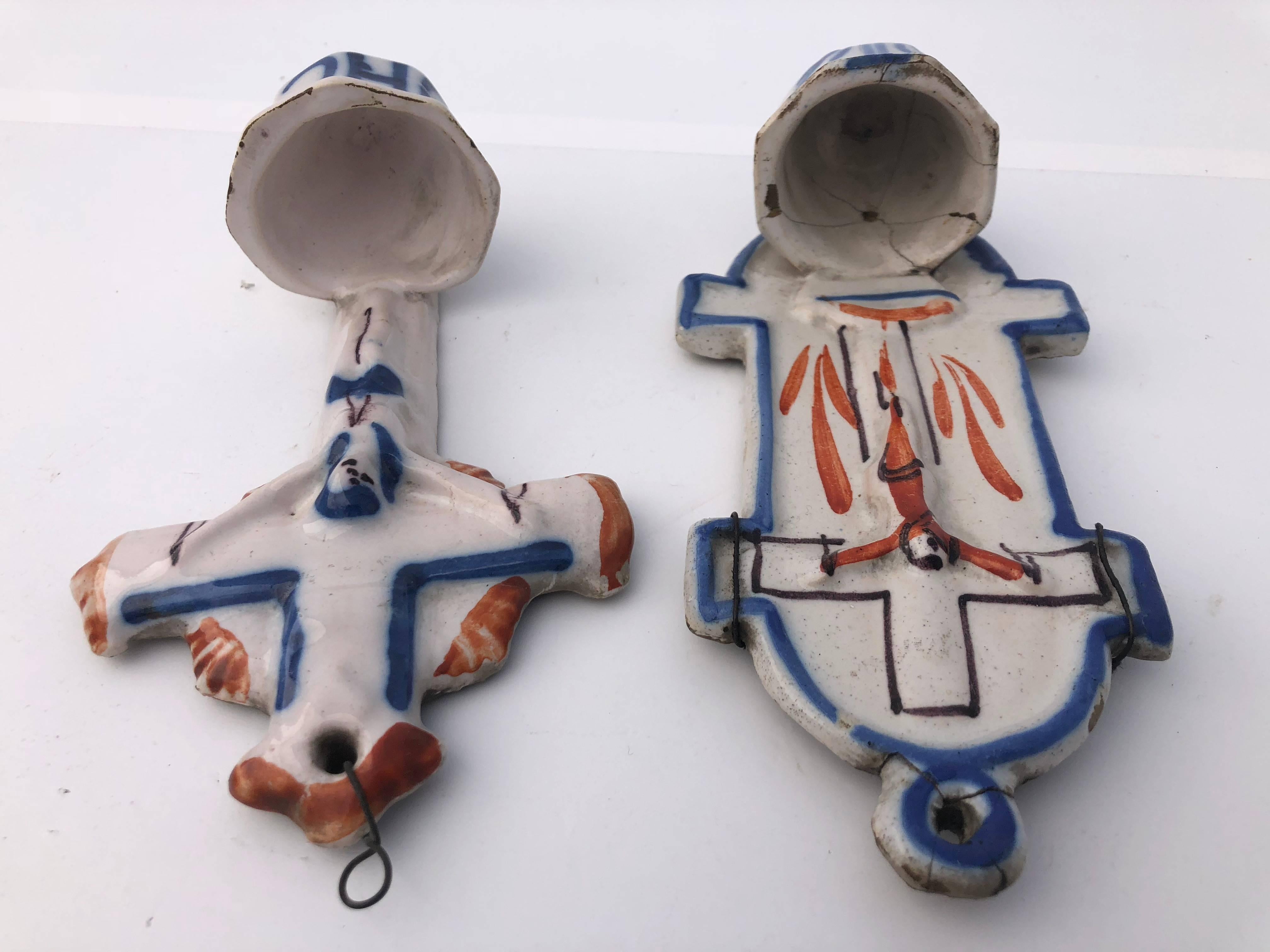 These are two incredible French Faience holy water fonts from the 1700s. Both have a crucifix and are hand painted with blue and orange touches. They are works of art and would be incredible on any wall.

 