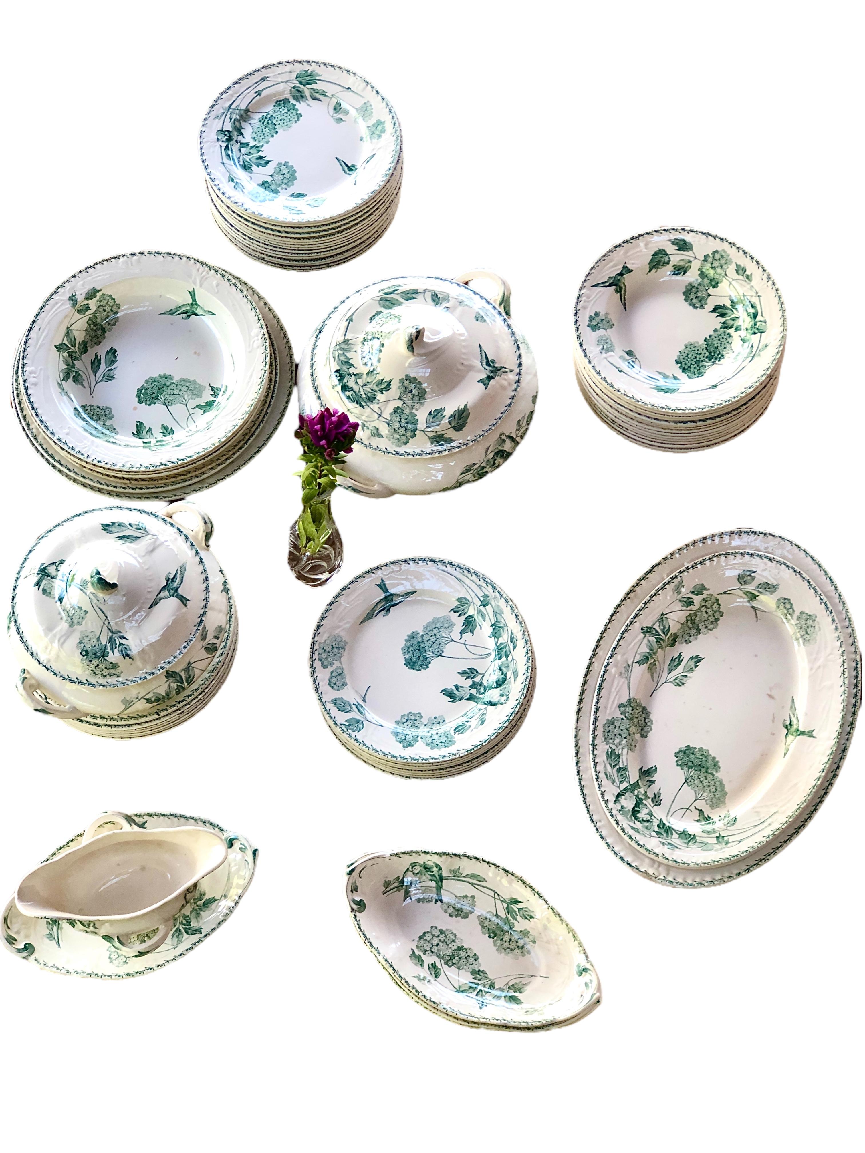 63 pieces of 19th-century Creil Montereau “Naples” French Faience Dinner Service, with serving pieces, in a white glaze with a simple green design of birds and flowers. In good antique condition with some marks and scratches from previous use.
30
