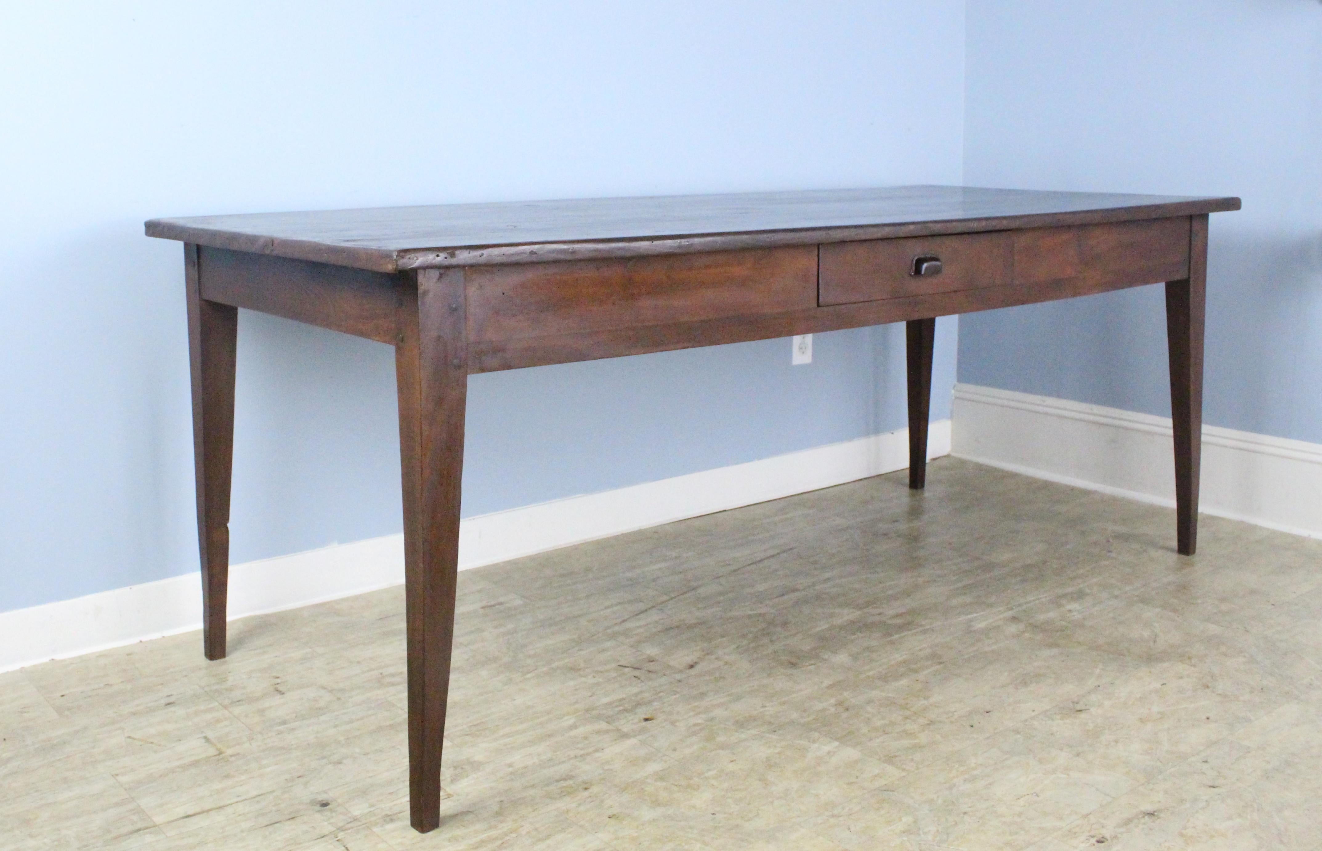 A handsome French dining or farm table with a chestnut base and framed poplar top. Rich color and nice patina. This table has a single roomy drawer. Apron height of 23.75 inches on the long sides and 25 inches at the ends. There are 73.5 inches