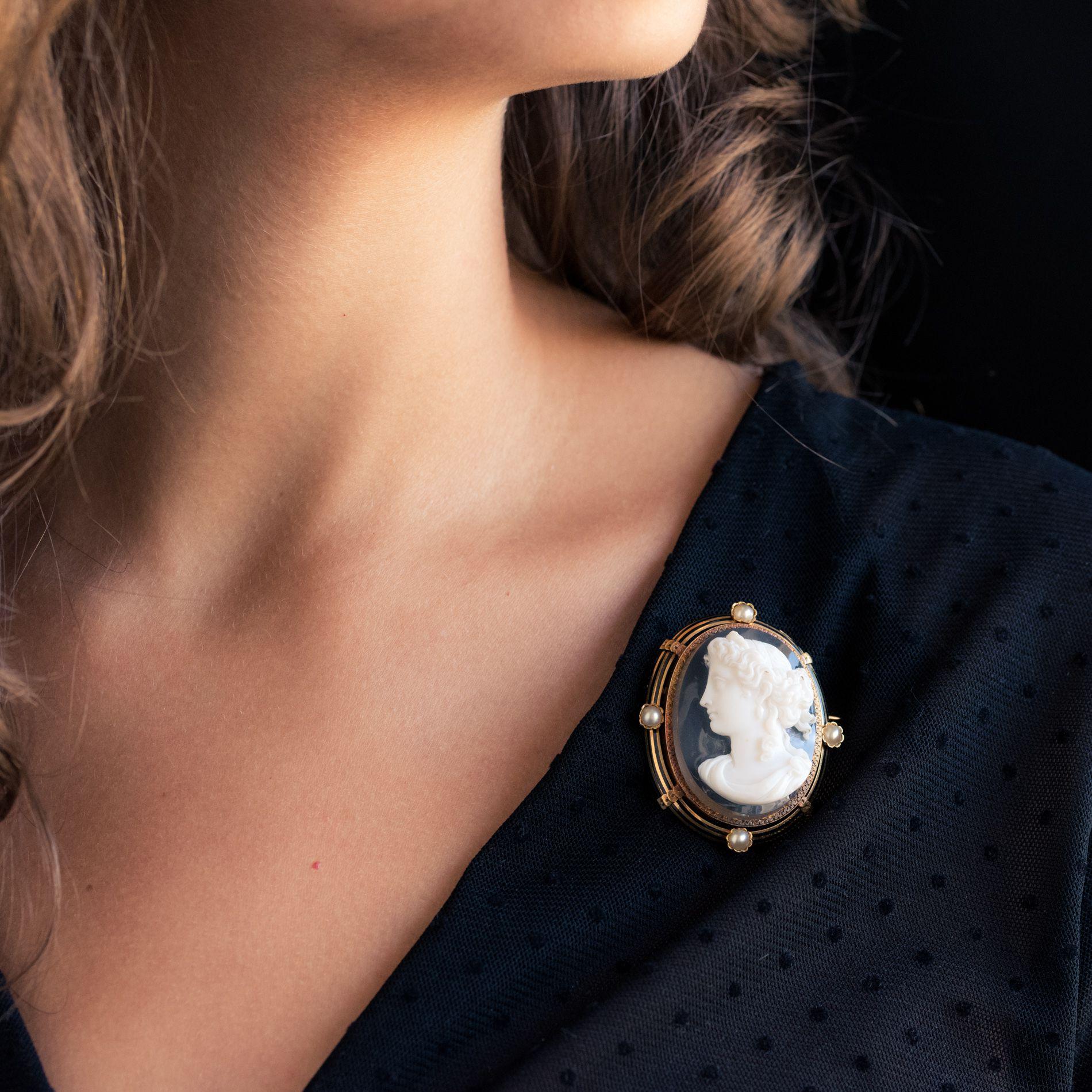 Cameo Brooch in 18 carat yellow gold, eagle head hallmark. 
This splendid antique brooch displays the left profile of a woman with her hair up, engraved into a single piece of agate. The surround is decorated with fine bands of black enamel with