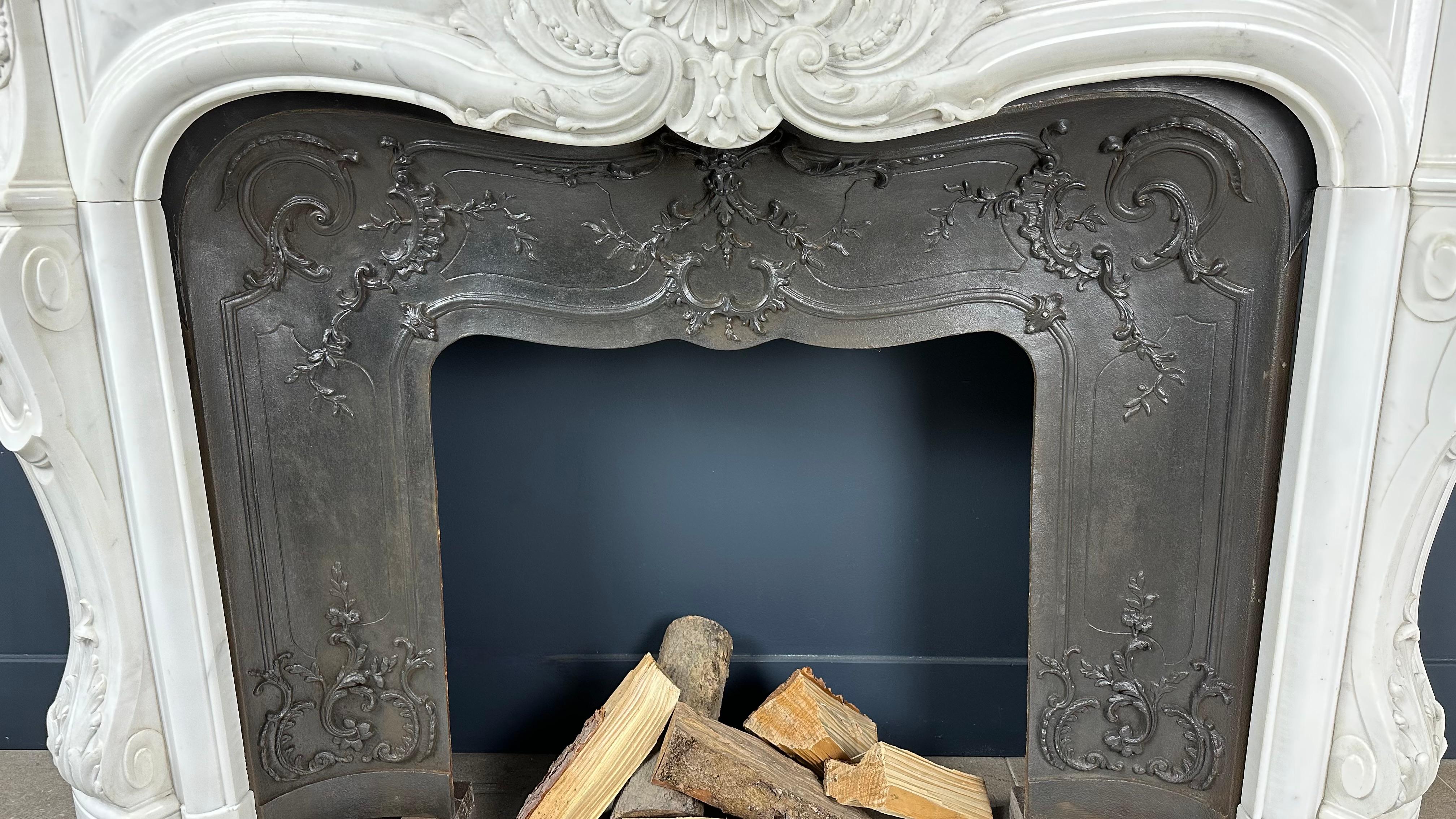 Experience the enchanting charm of our French antique shell fireplace, a masterpiece infused with history and style, now elevated with an added dimension of luxury. Crafted from precious Carrara marble, this fireplace exudes timeless elegance and a