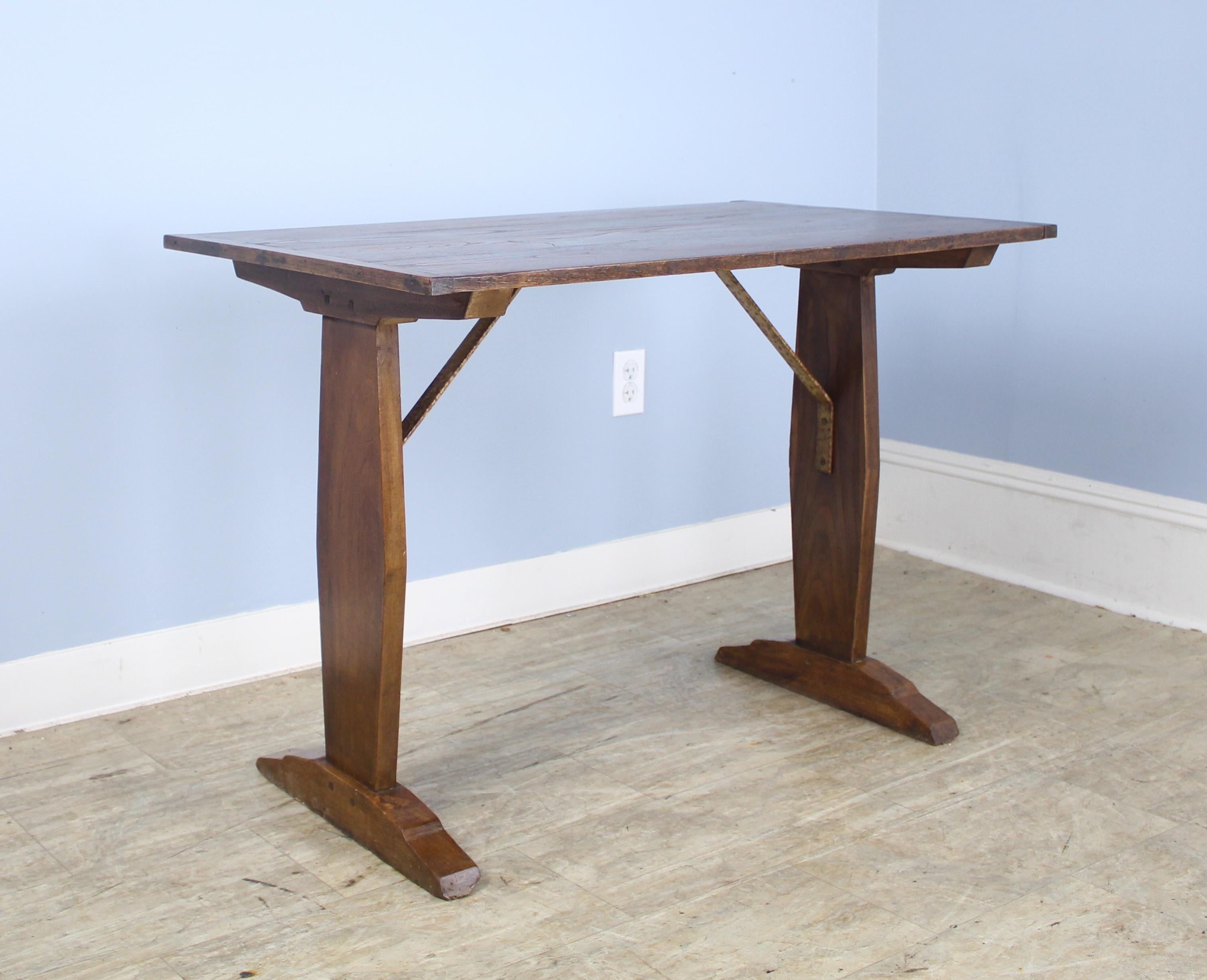 A pretty little breakfast or occasional table, originally from a French eatery. Good looking fruitwood color and grain, with interesting distressed iron supports. If you are looking for two, we have an almost identical one, reference #0621-M68B.